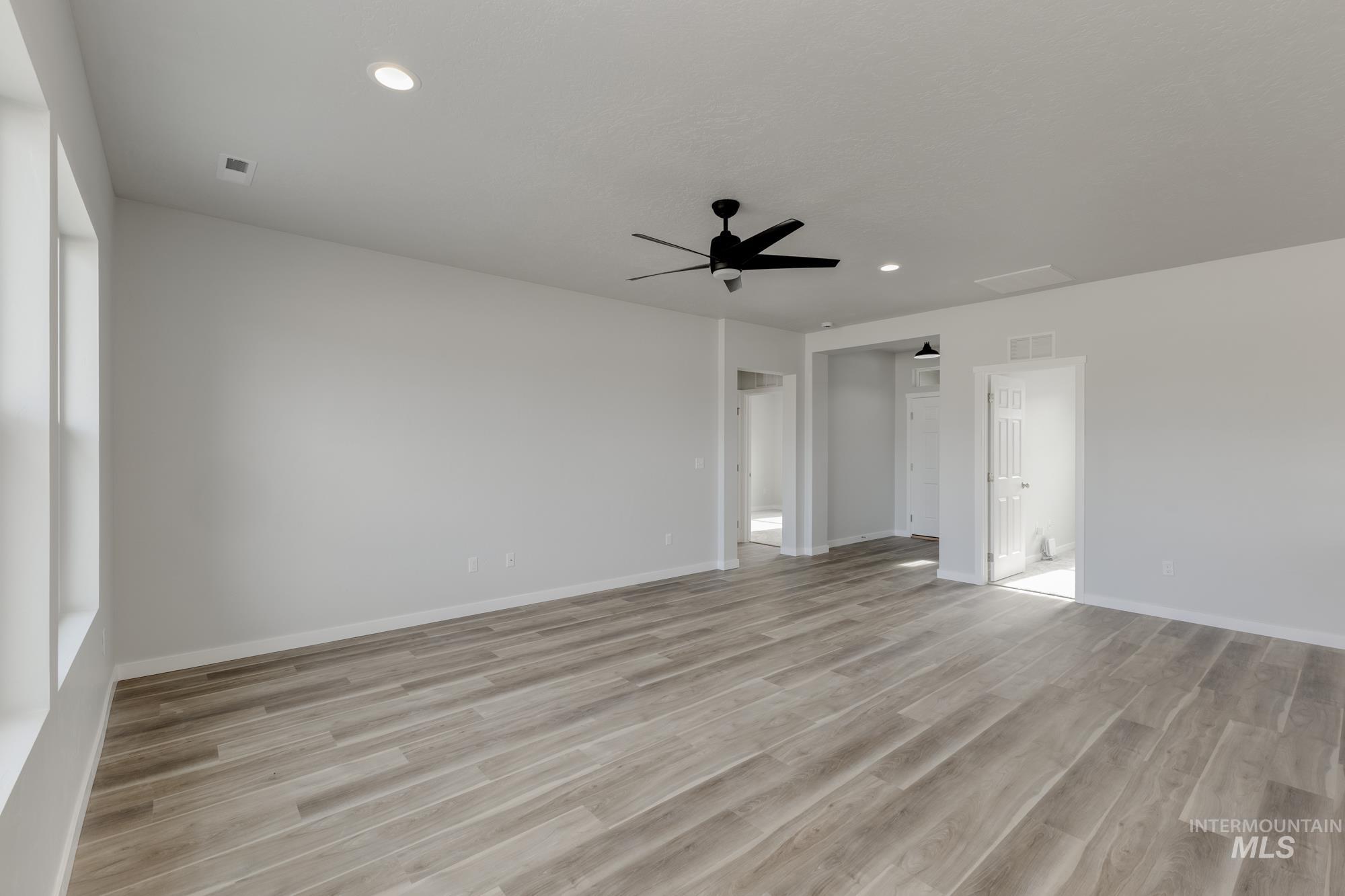 Spare room with light wood-style floors, recessed lighting, and ceiling fan
