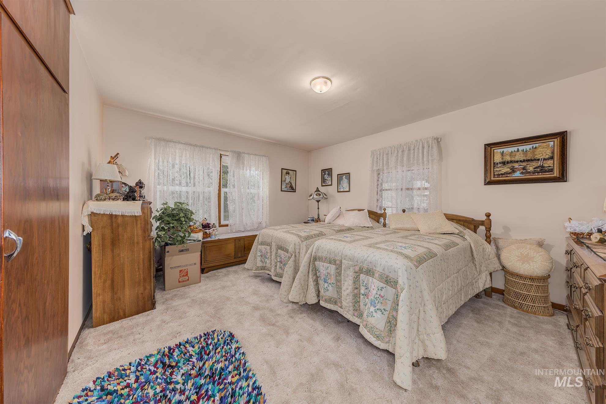 Bedroom featuring light carpet and a closet