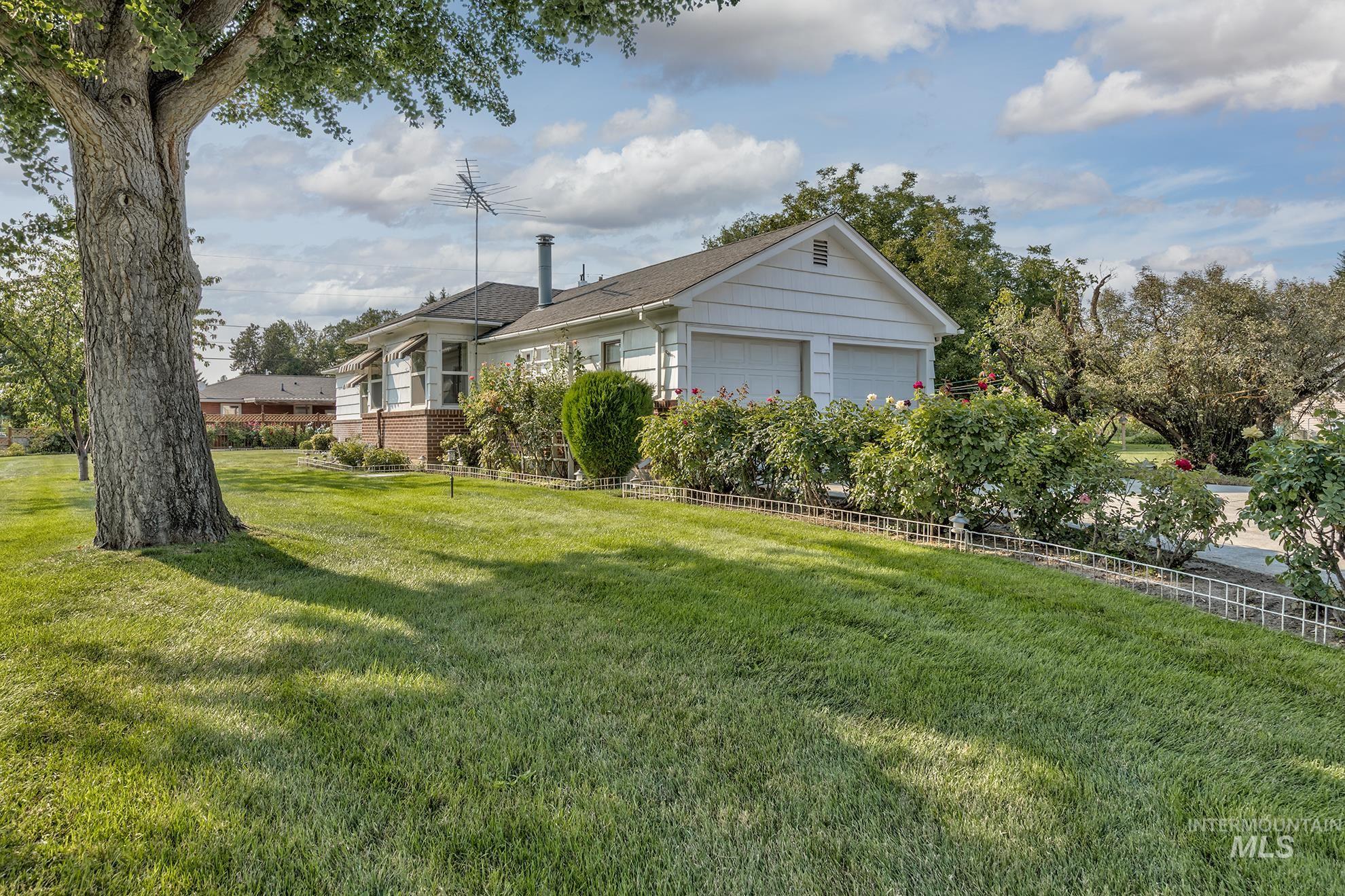 View of grassy yard featuring a garage
