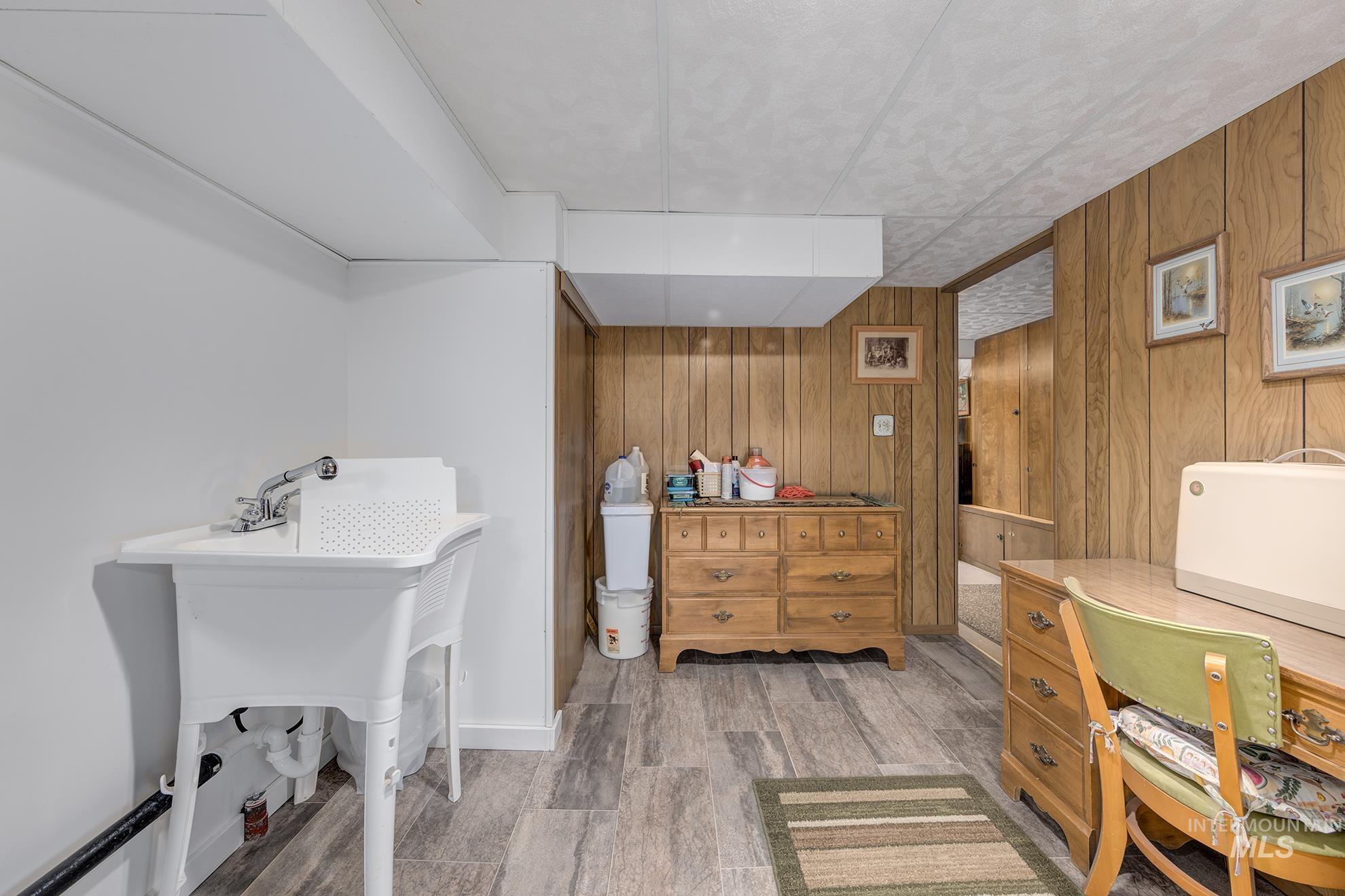 Office with wood walls and light wood-style floors