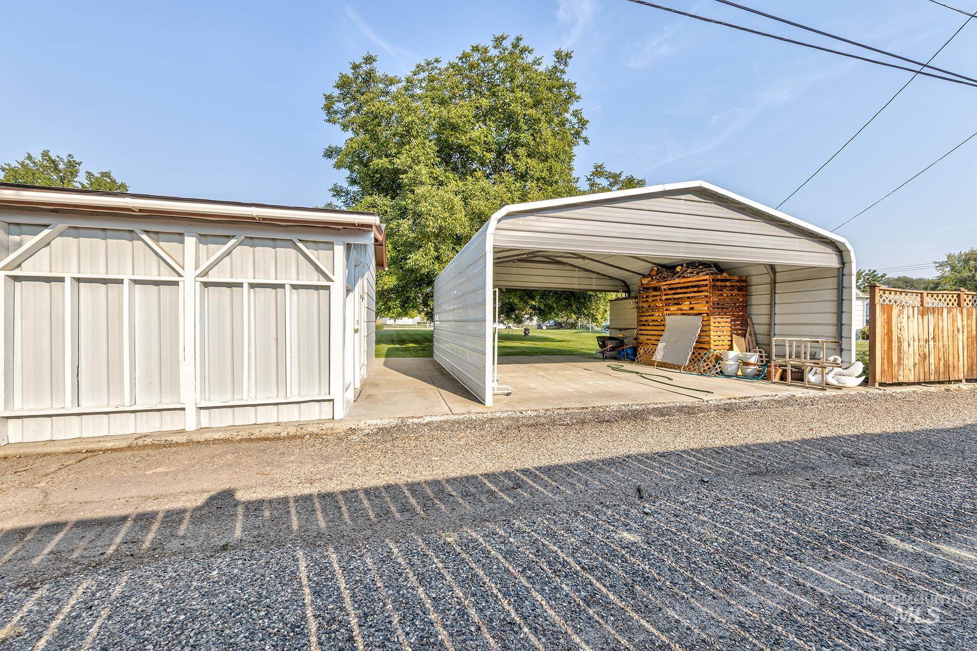Garage featuring a detached carport
