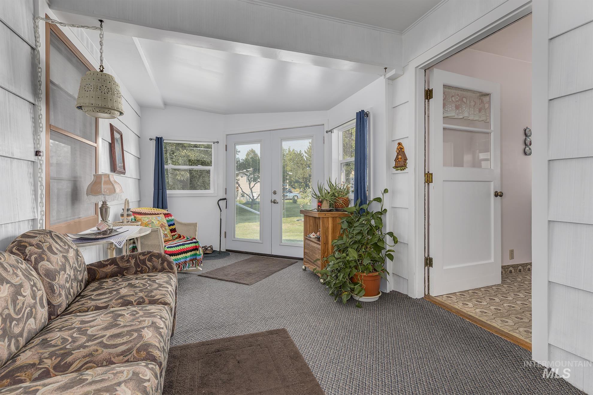 Living area featuring french doors and carpet flooring