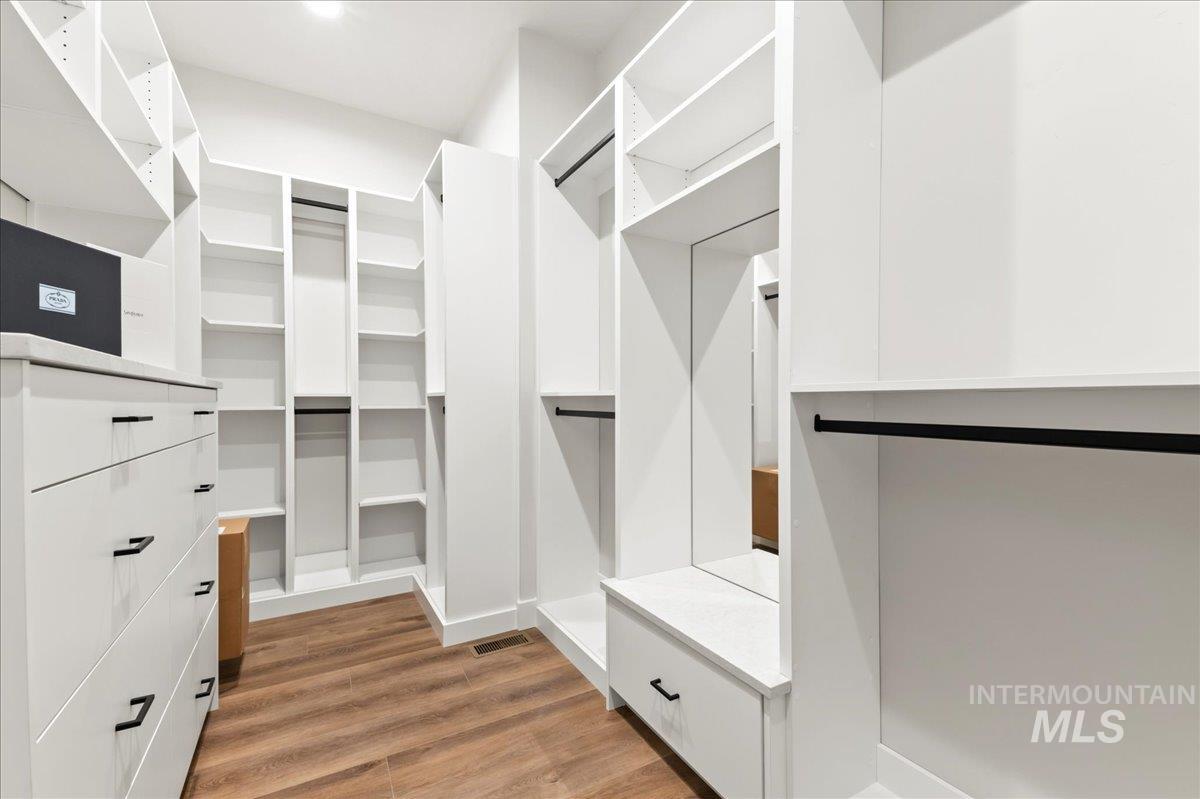 Walk in closet featuring light wood finished floors