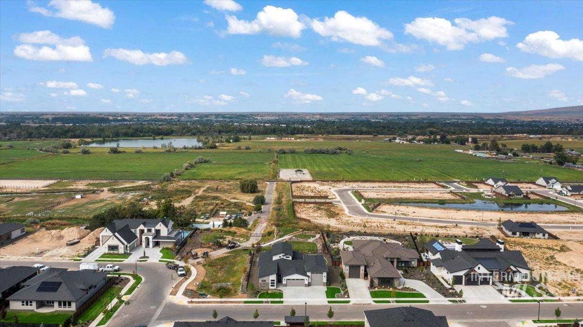 Aerial view of property and surrounding area with a large body of water, nearby suburban area, and rural landscape