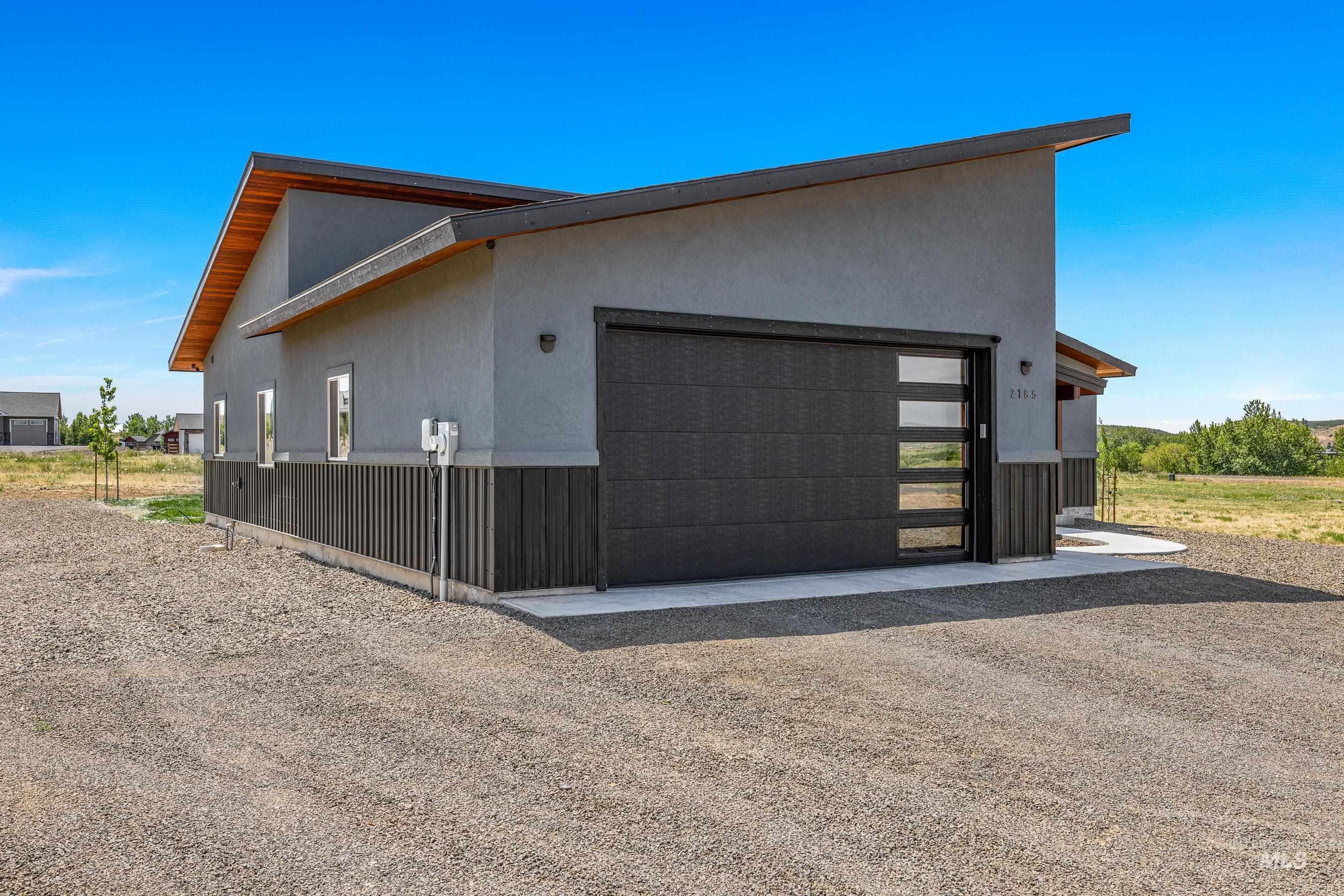 View of side of property with an attached garage and stucco siding