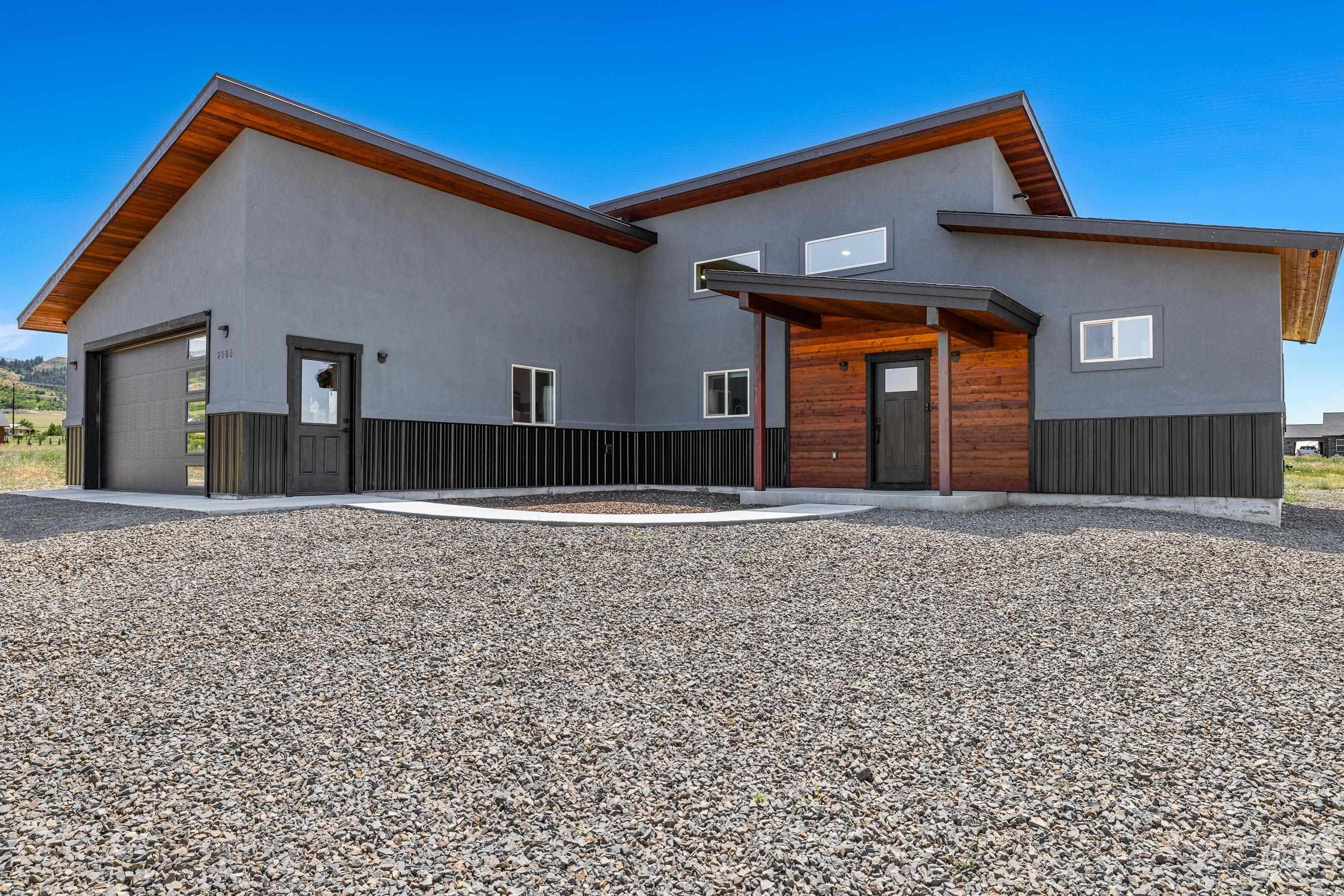 View of front of house with a garage and stucco siding