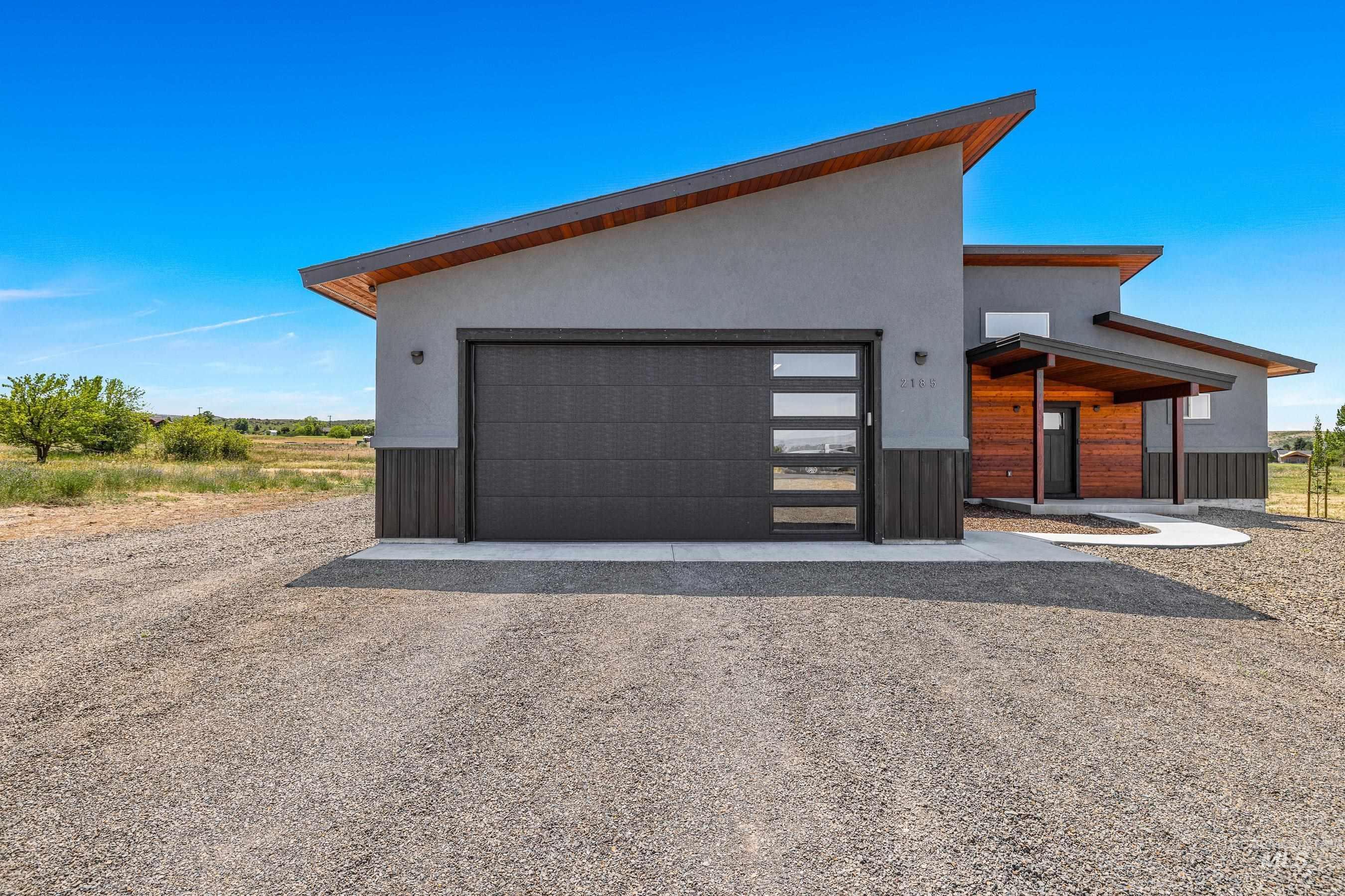 View of front of home with driveway, stucco siding, and a garage