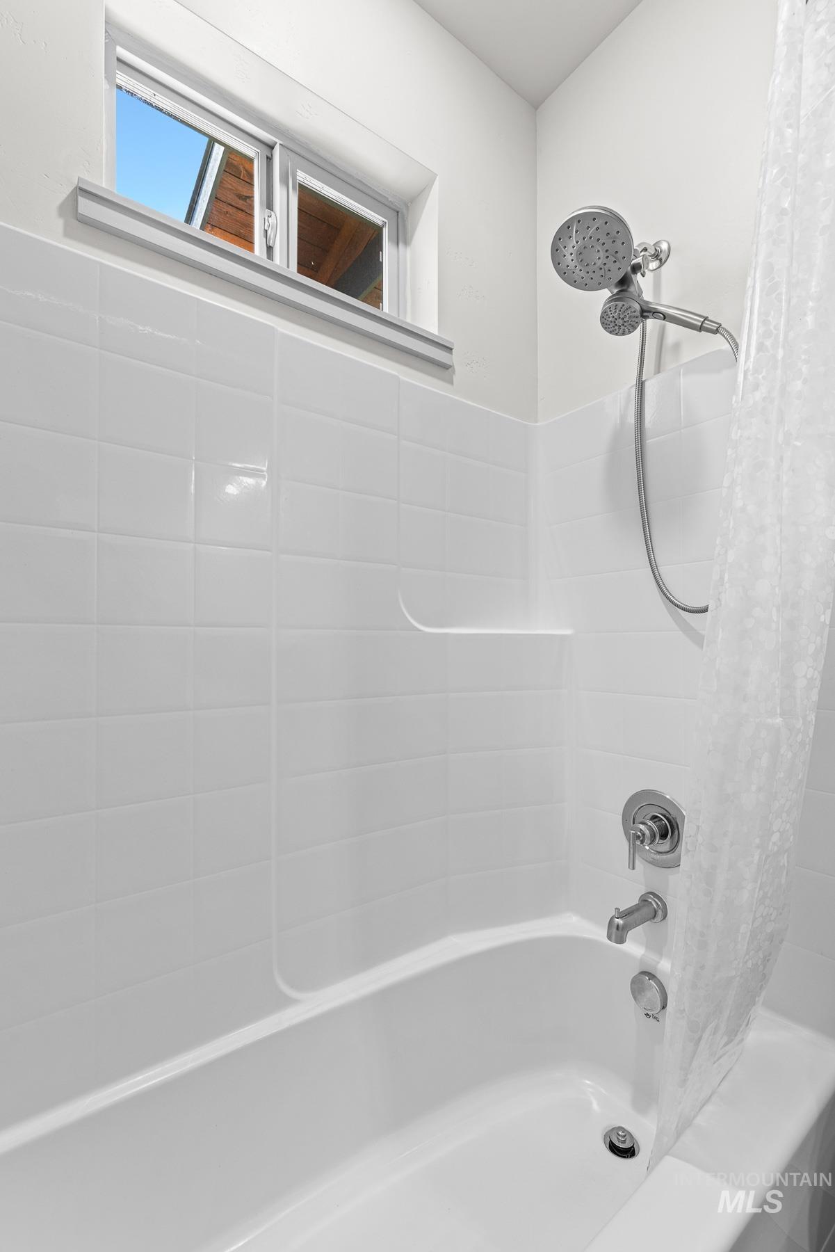 Full bathroom with shower / bath combo with shower curtain