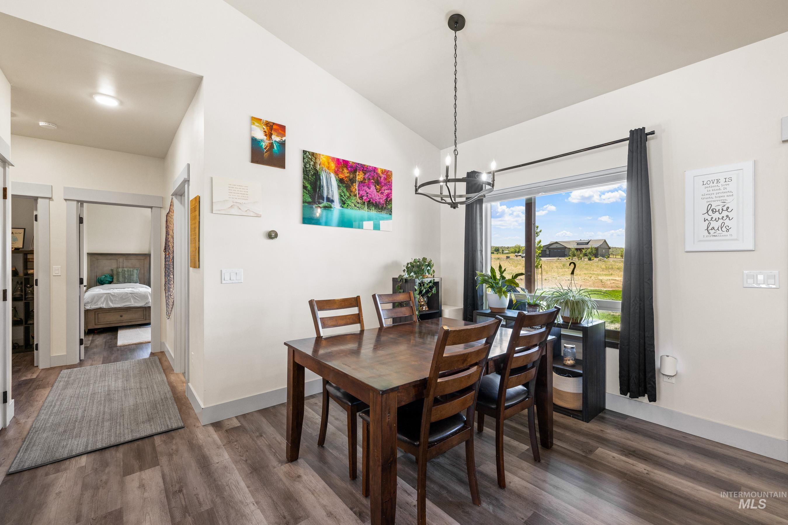 Dining room featuring wood finished floors and a chandelier
