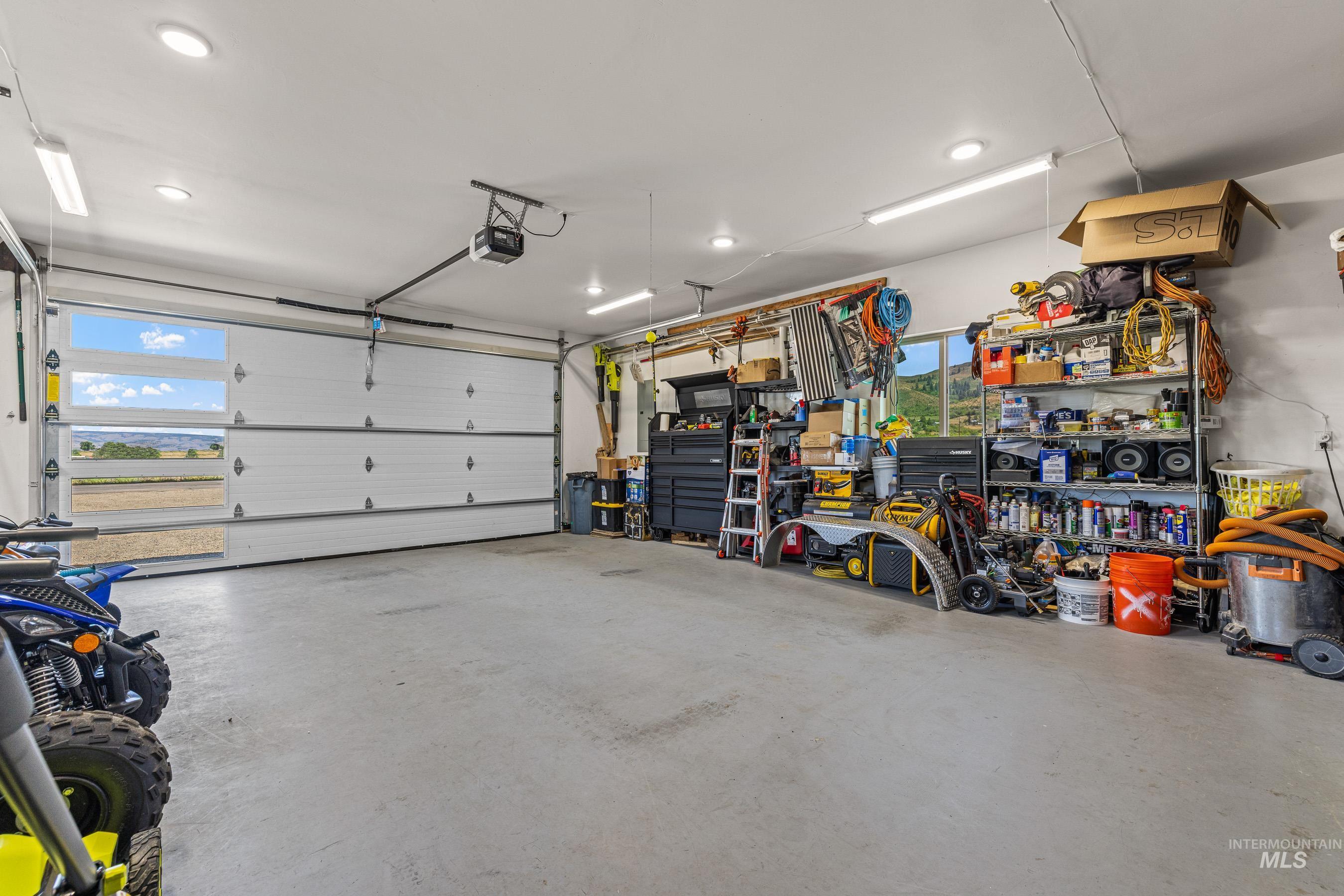 Garage featuring a garage door opener and recessed lighting