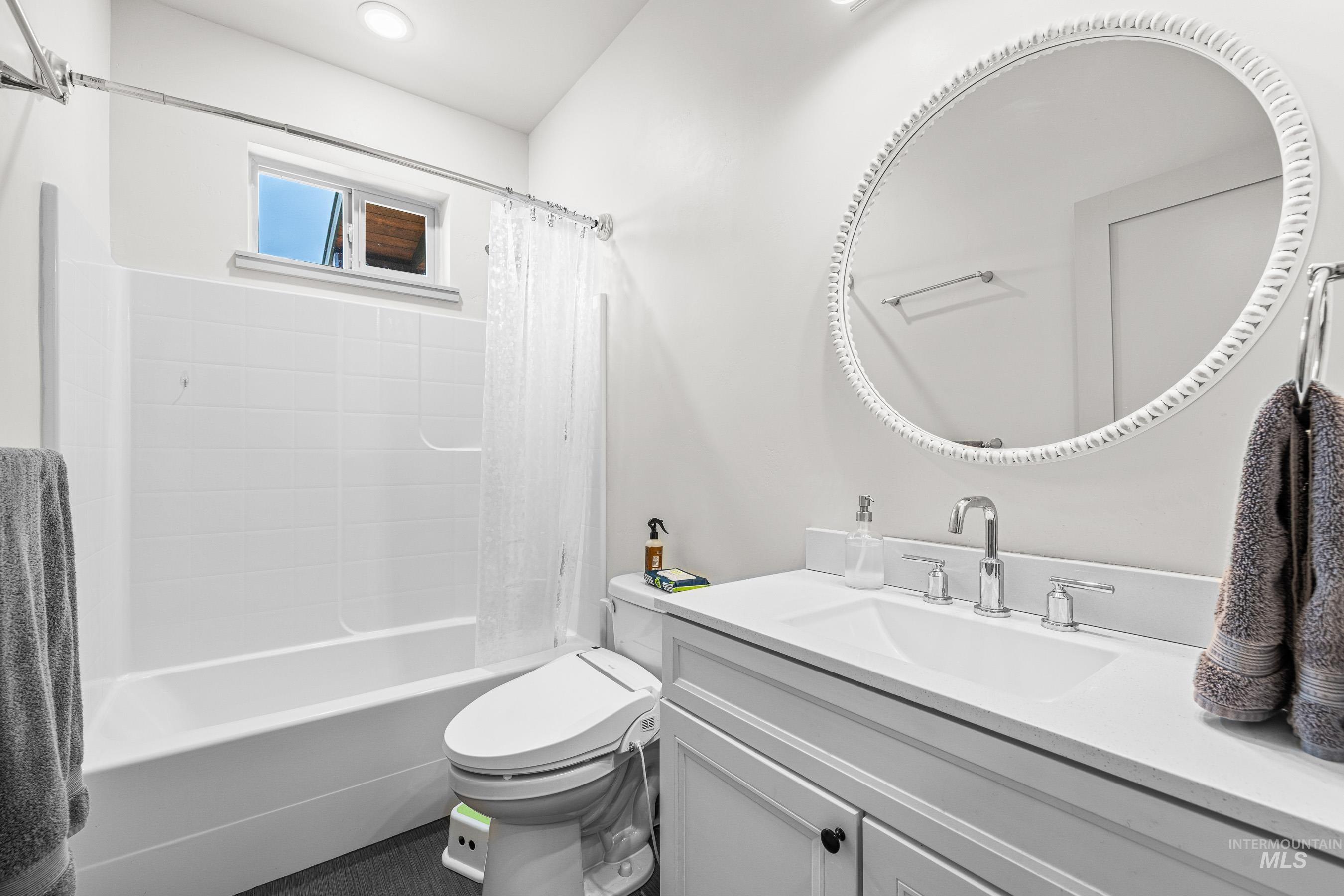 Full bath with vanity and shower / tub combo with curtain