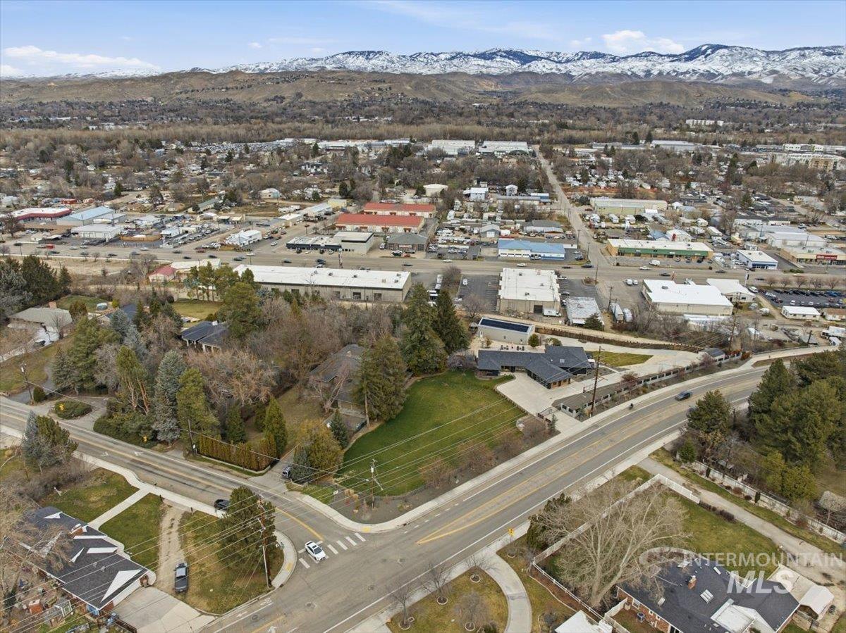 Aerial view of property's location with a mountain backdrop and nearby suburban area