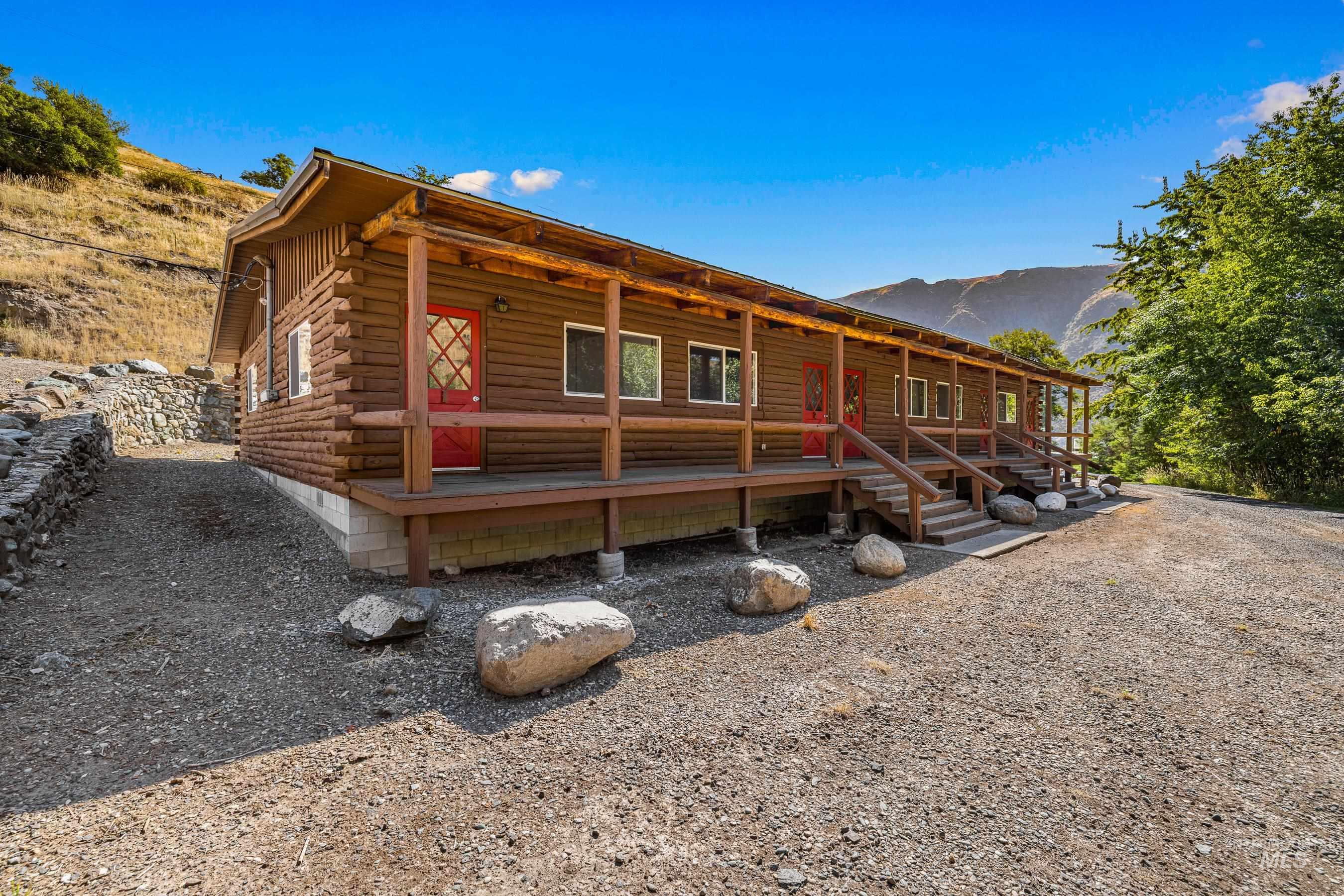 Log-style house featuring log exterior, a porch, and a mountain view