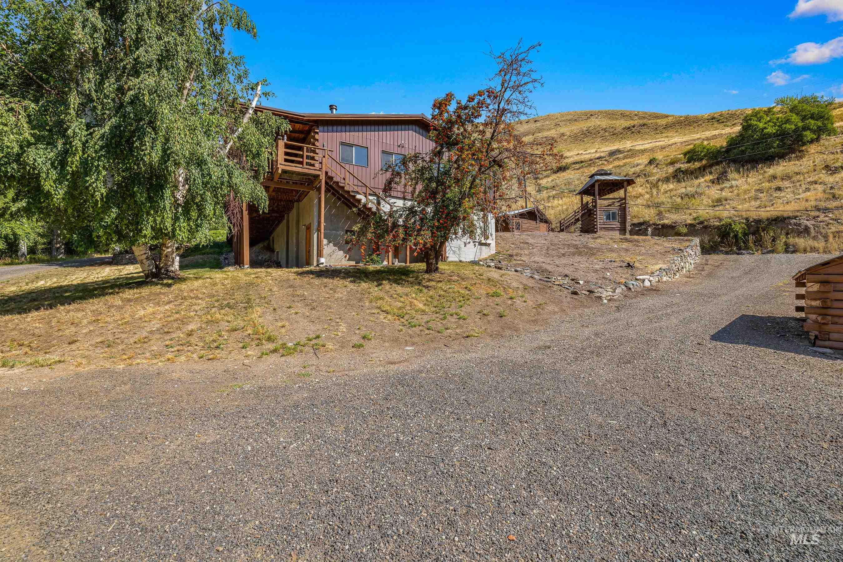 View of front of house with stairway and a wooden deck