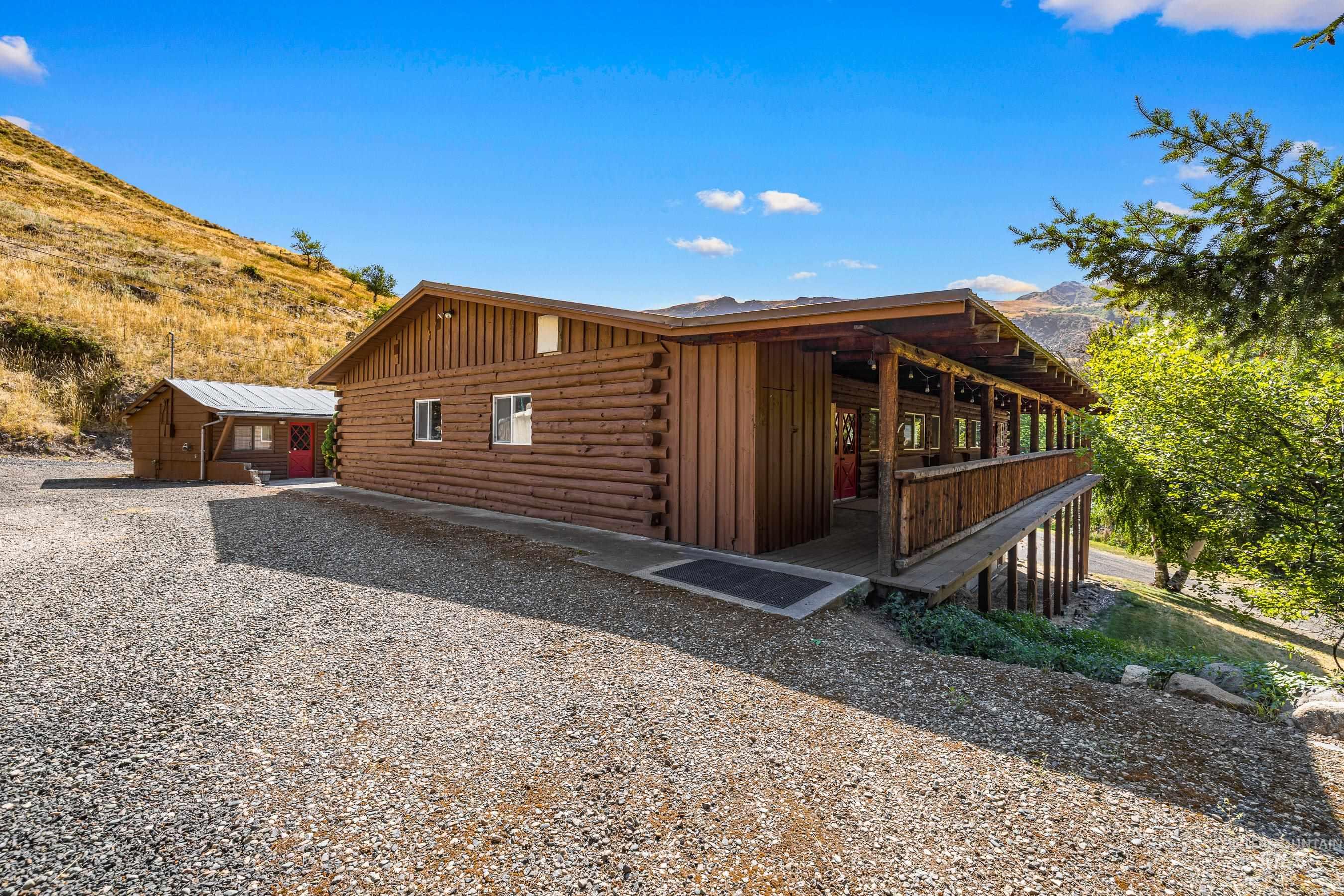 View of side of property with log siding, board and batten siding, and a mountain view