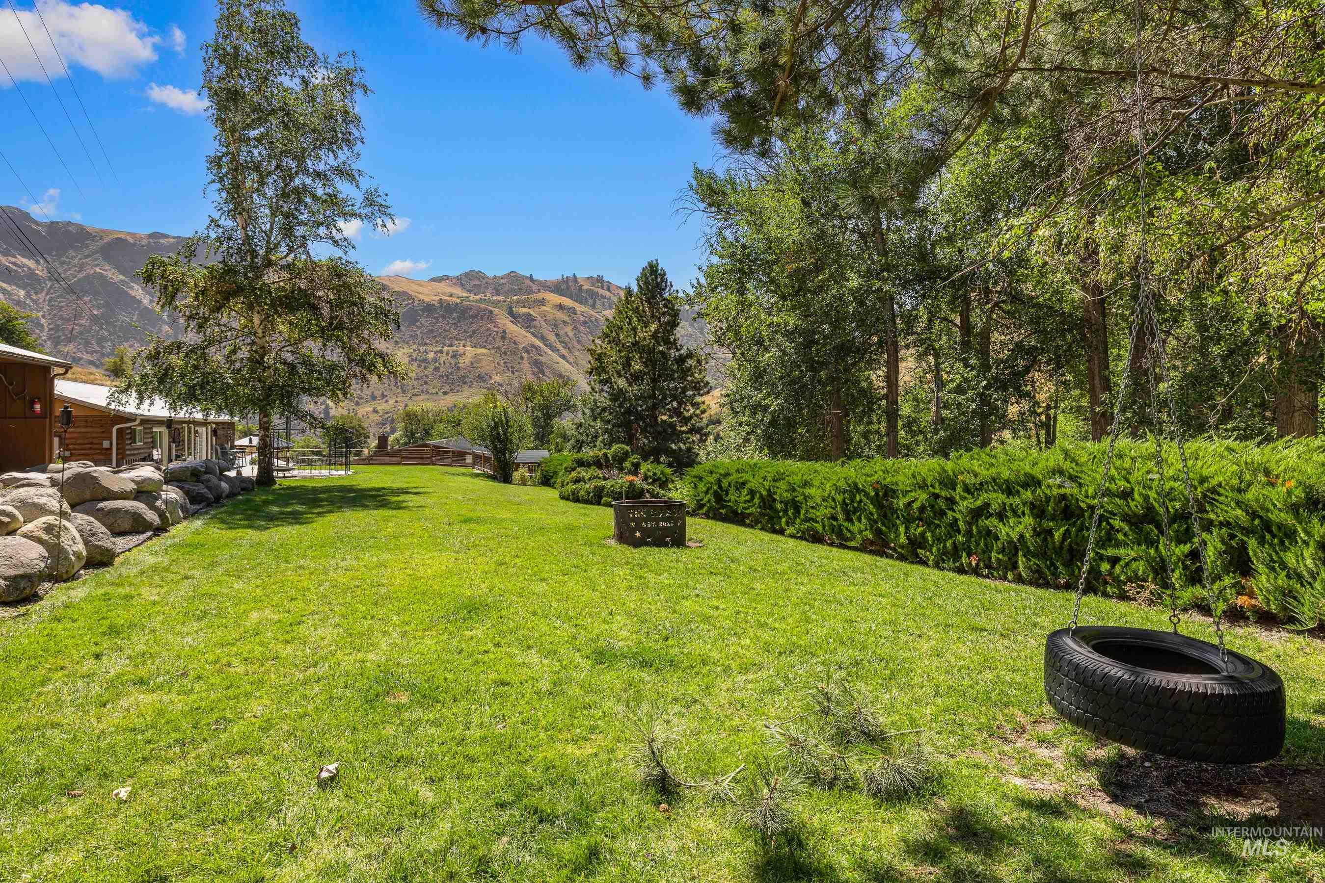 View of green lawn featuring a mountain view