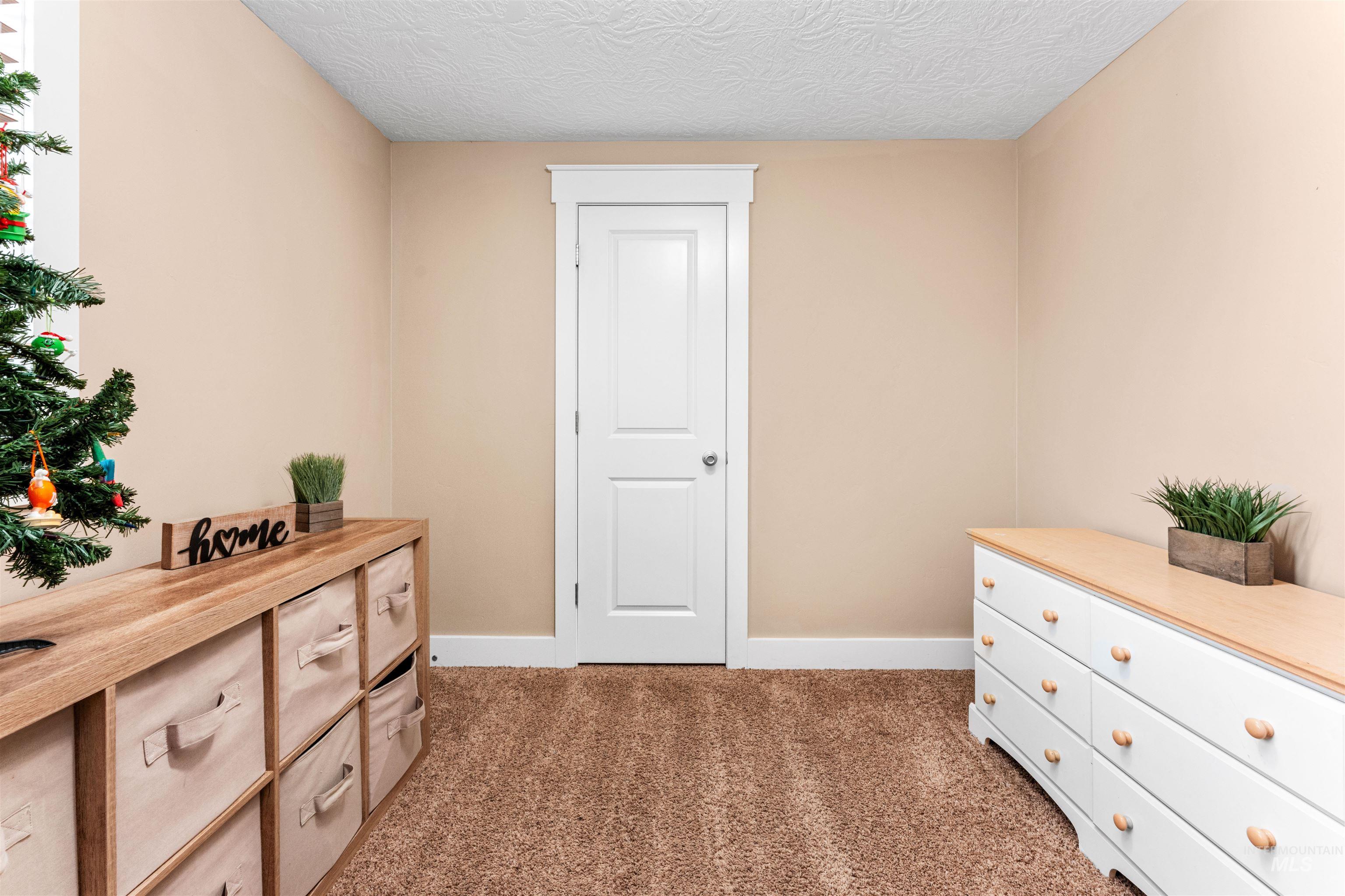 Living area featuring carpet floors and a textured ceiling