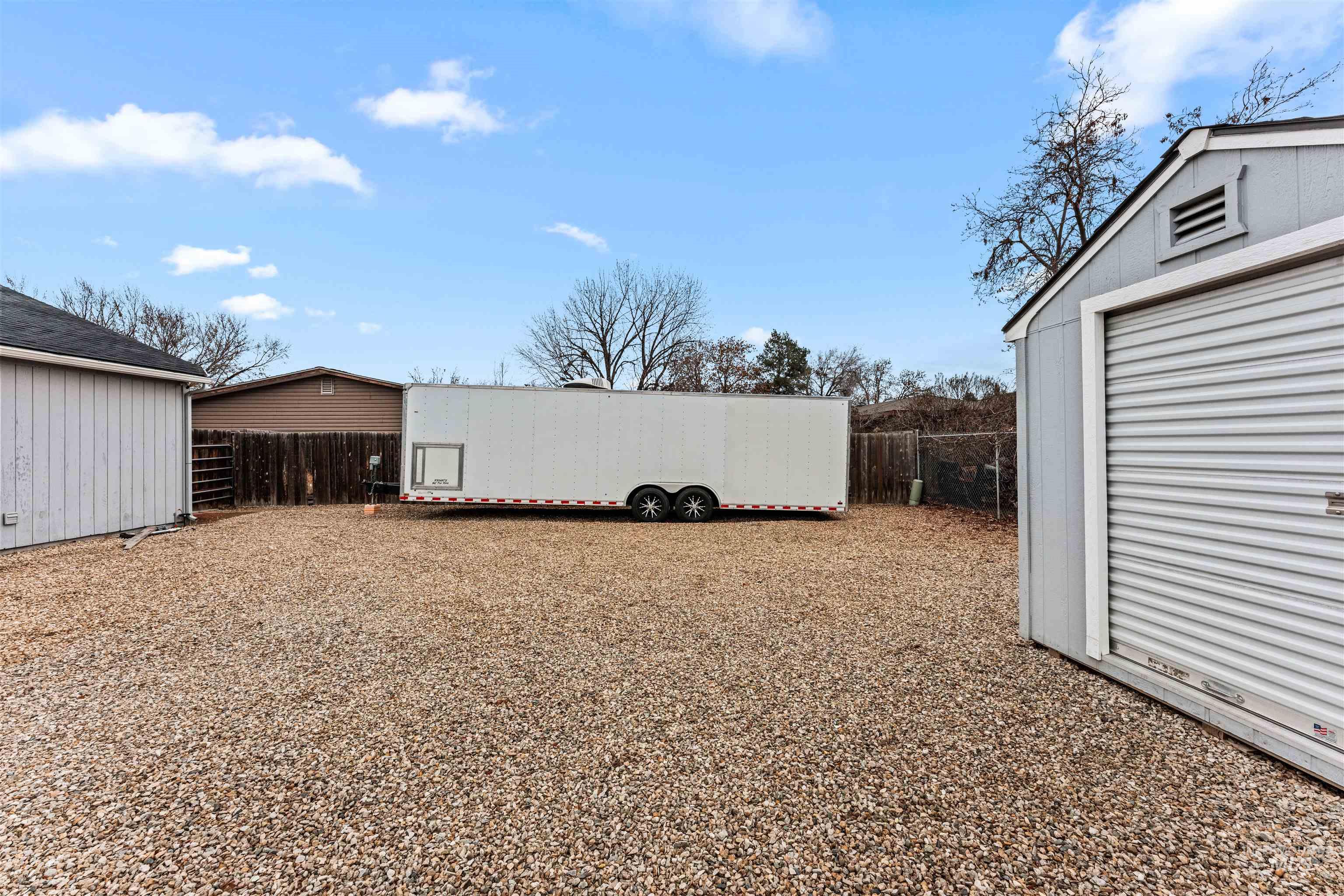 Fenced backyard featuring an outdoor structure