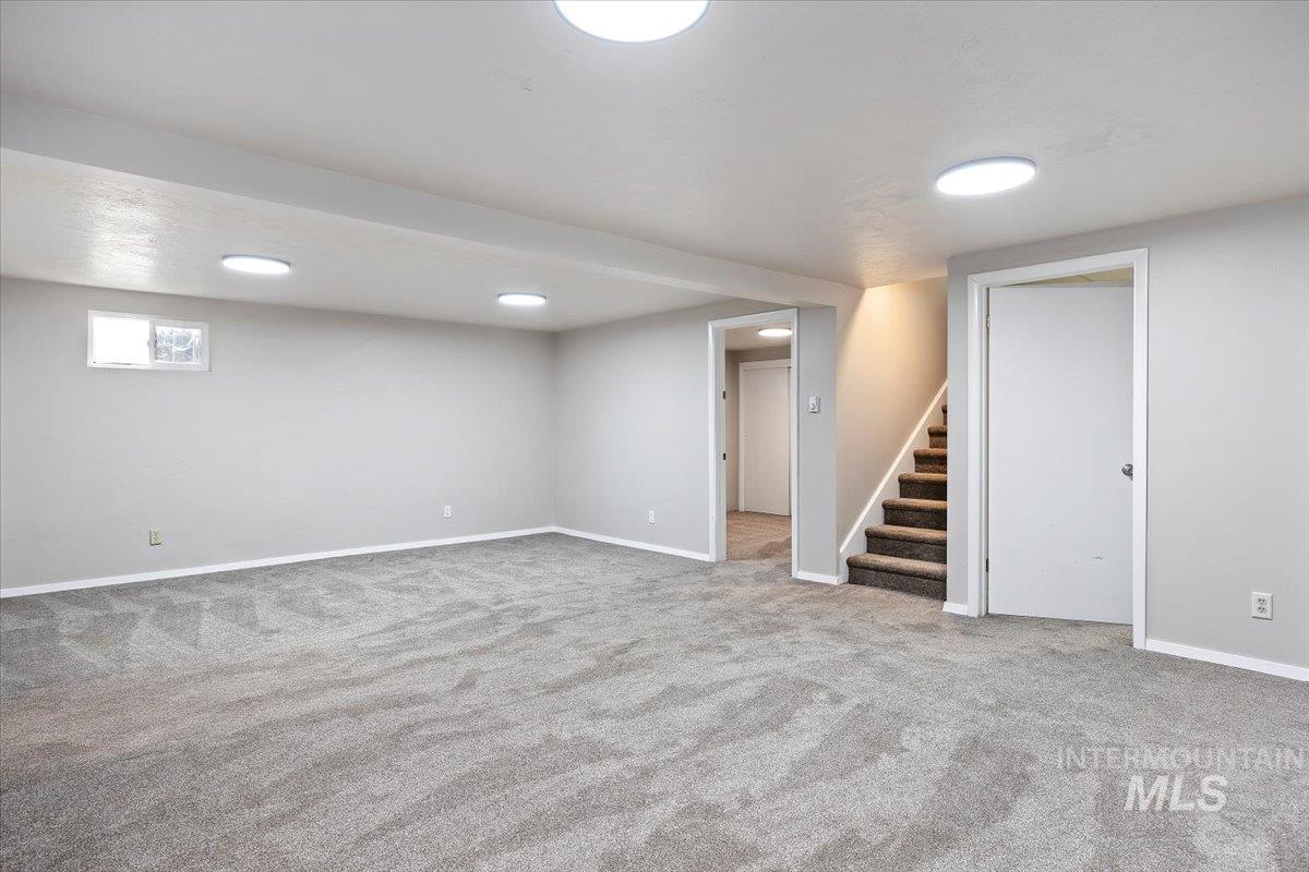 Basement featuring carpet floors and stairway