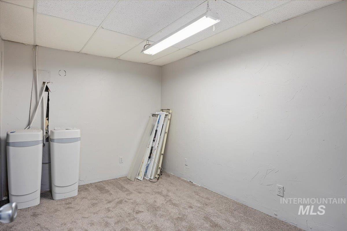 Carpeted empty room with a drop ceiling