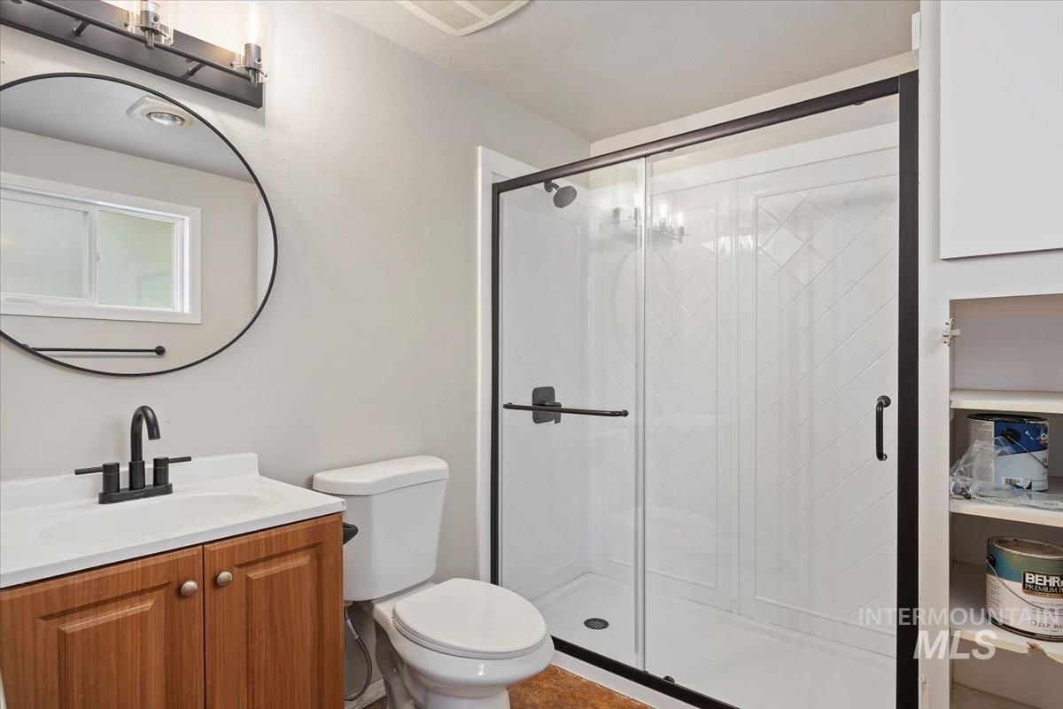 Bathroom with vanity and a stall shower