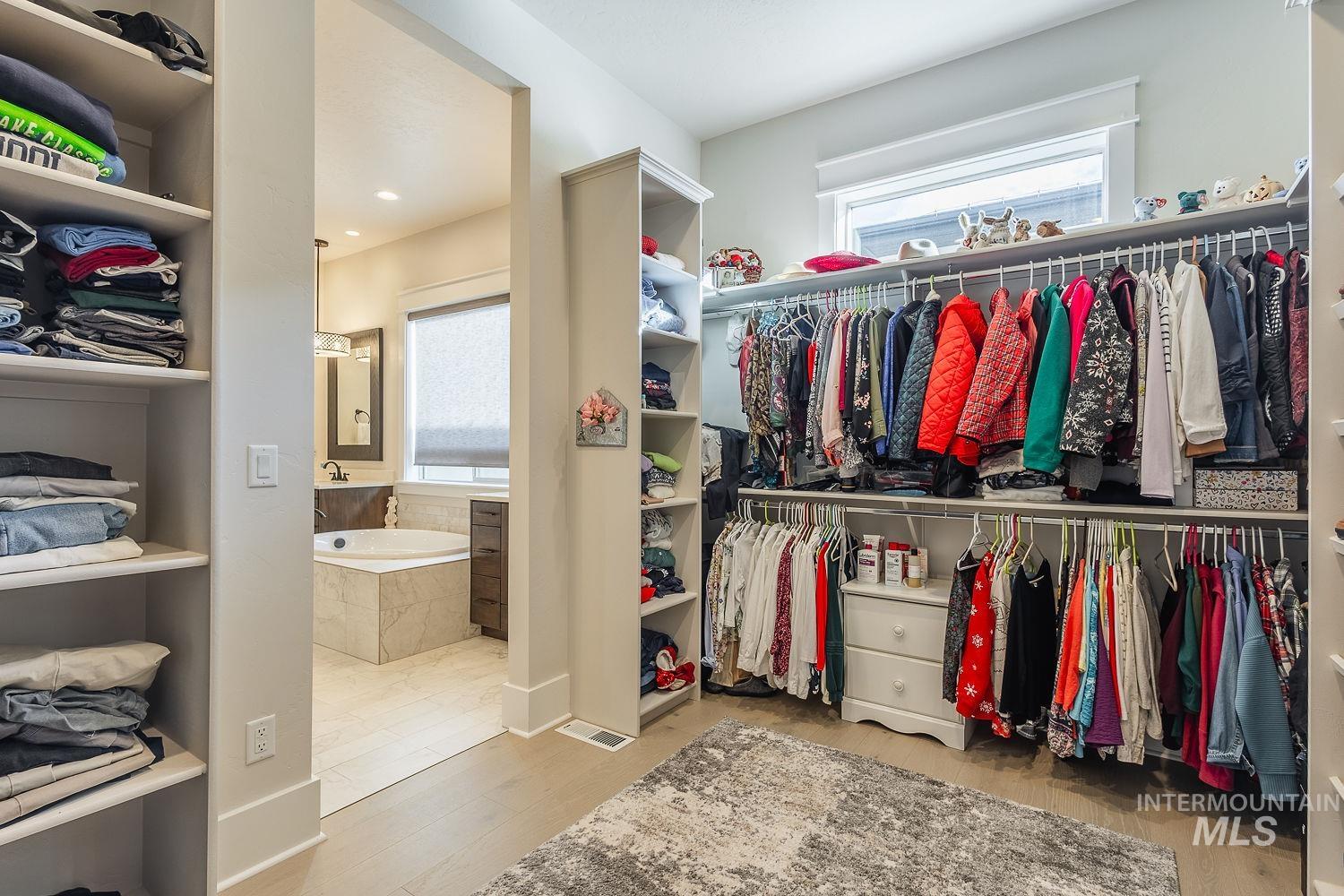 Walk in closet featuring light wood finished floors