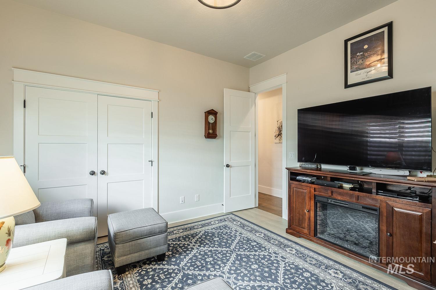 Living area with light wood-style floors and baseboards