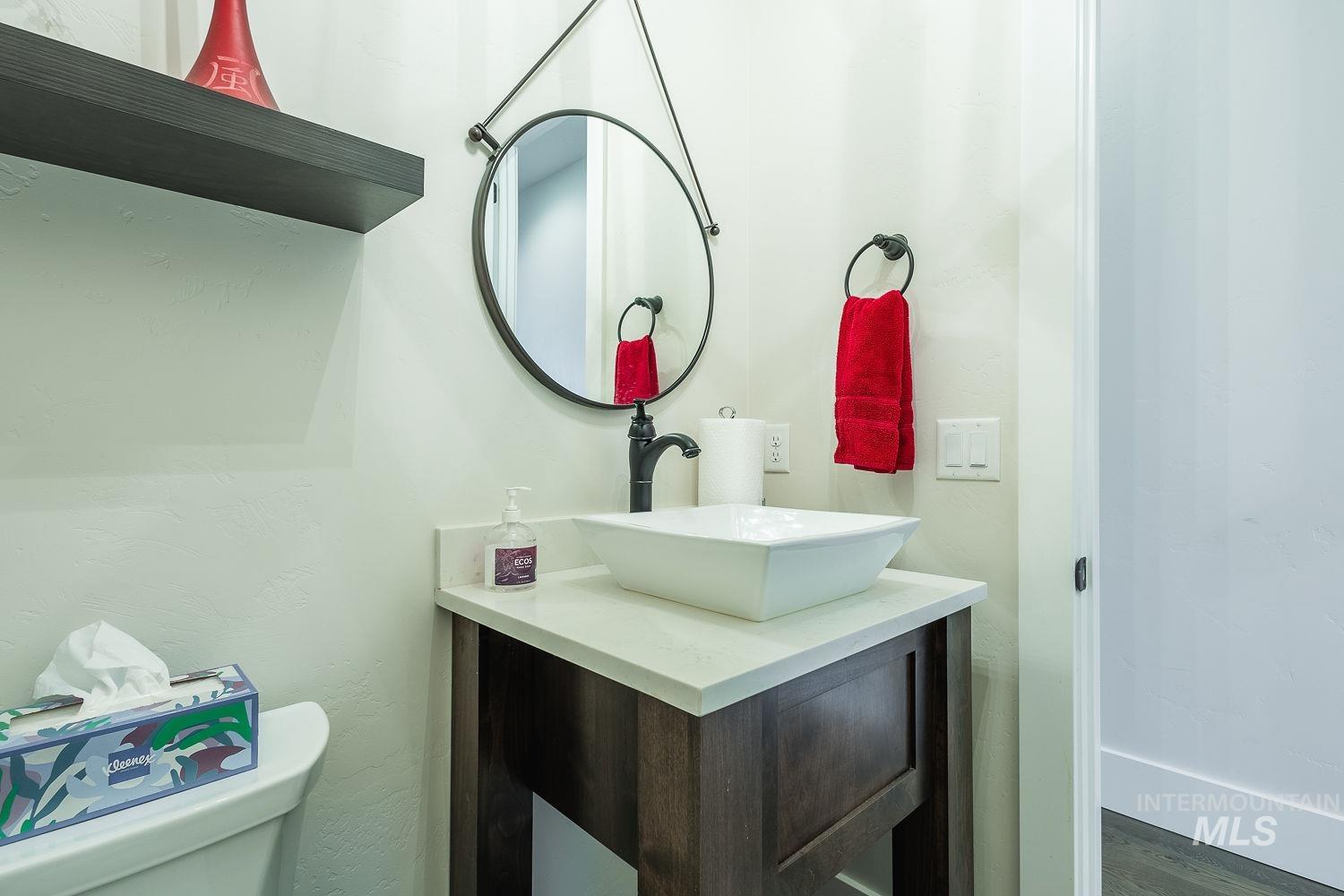 Bathroom featuring vanity and wood finished floors