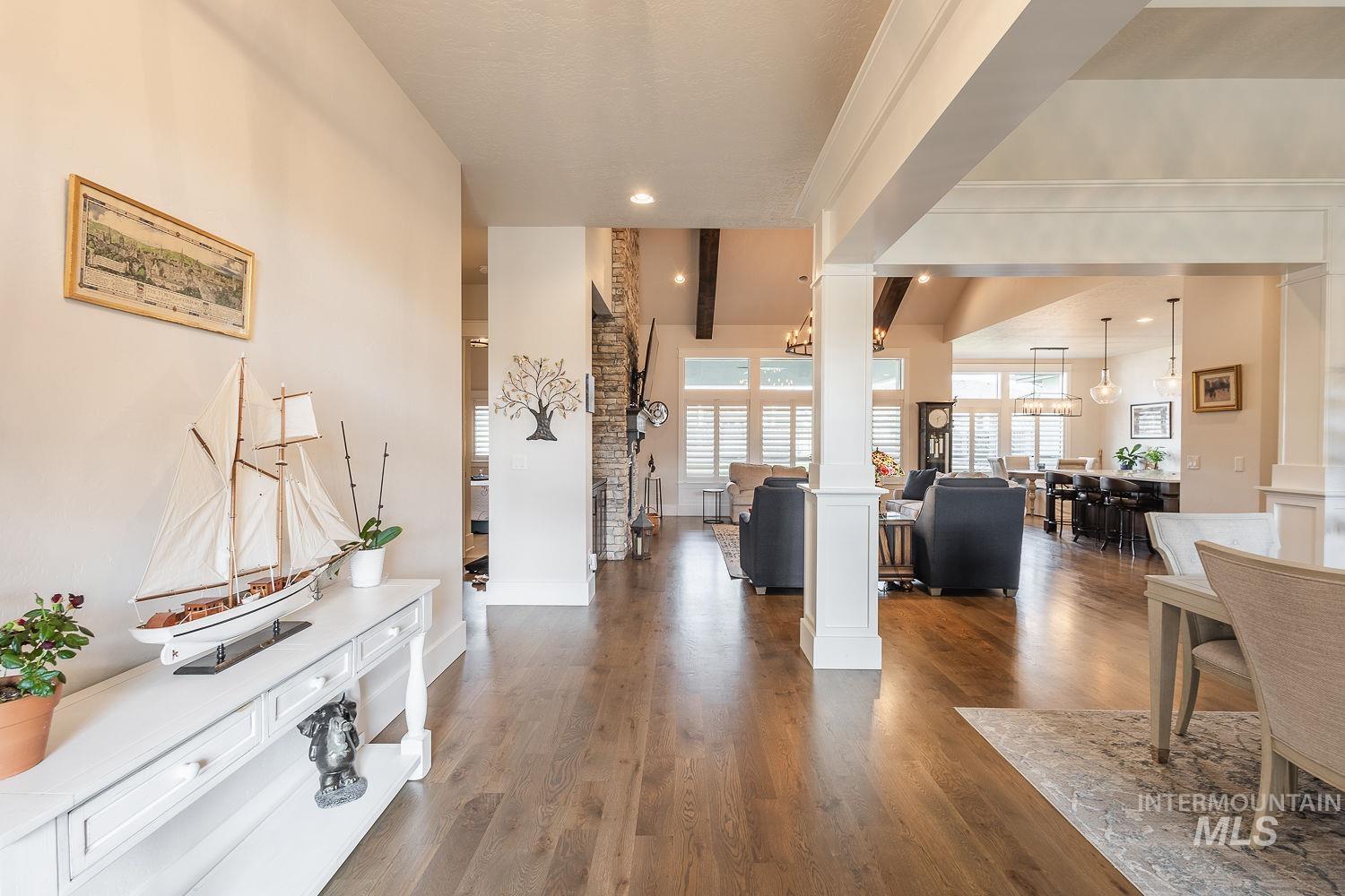 Entrance foyer featuring decorative columns and wood finished floors