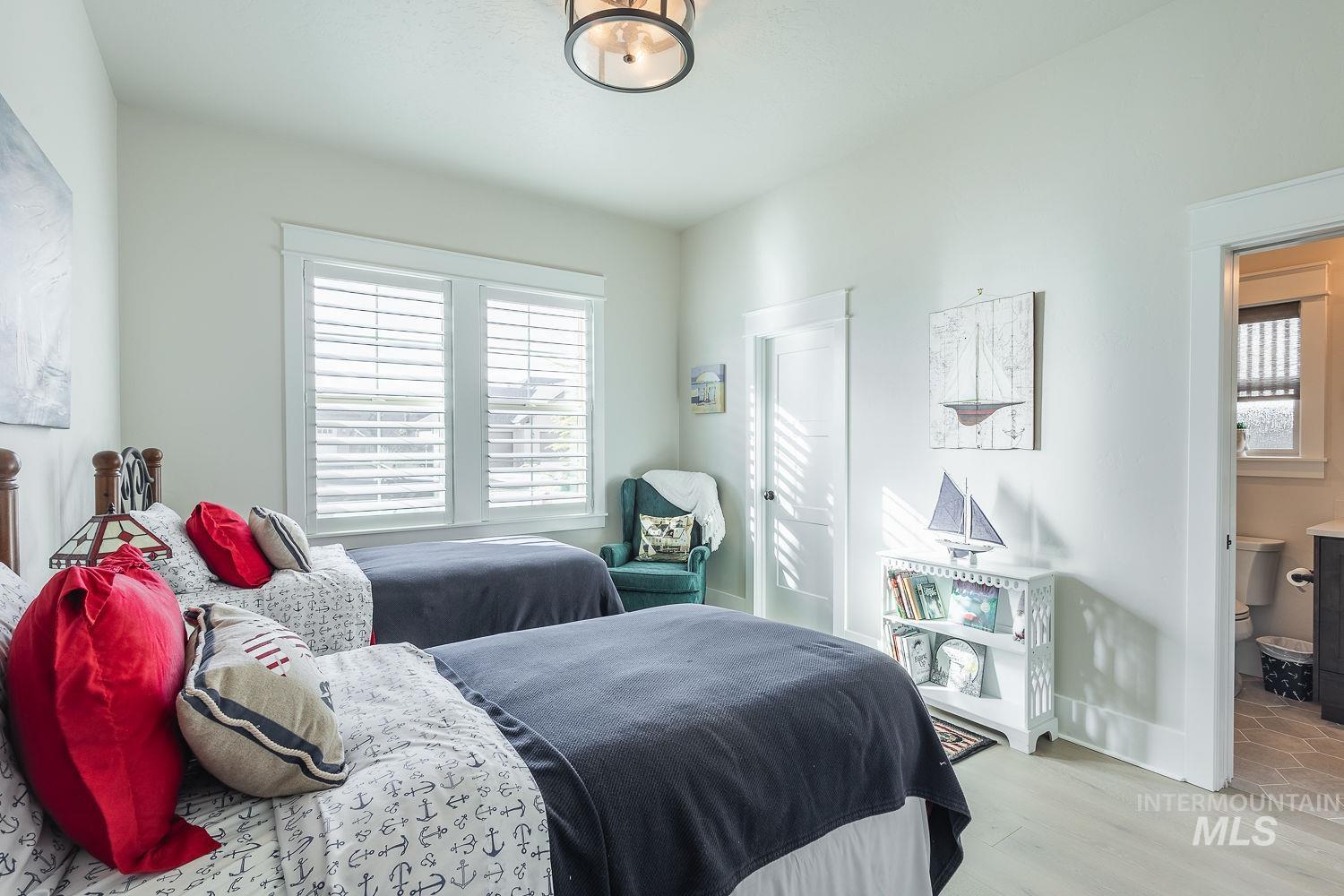 Bedroom with wood finished floors and baseboards