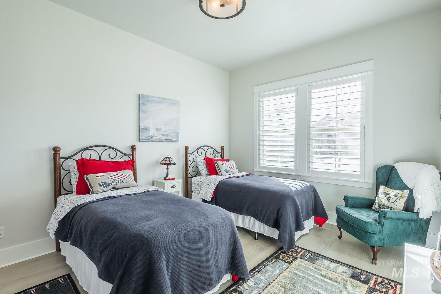 Bedroom featuring wood finished floors and baseboards