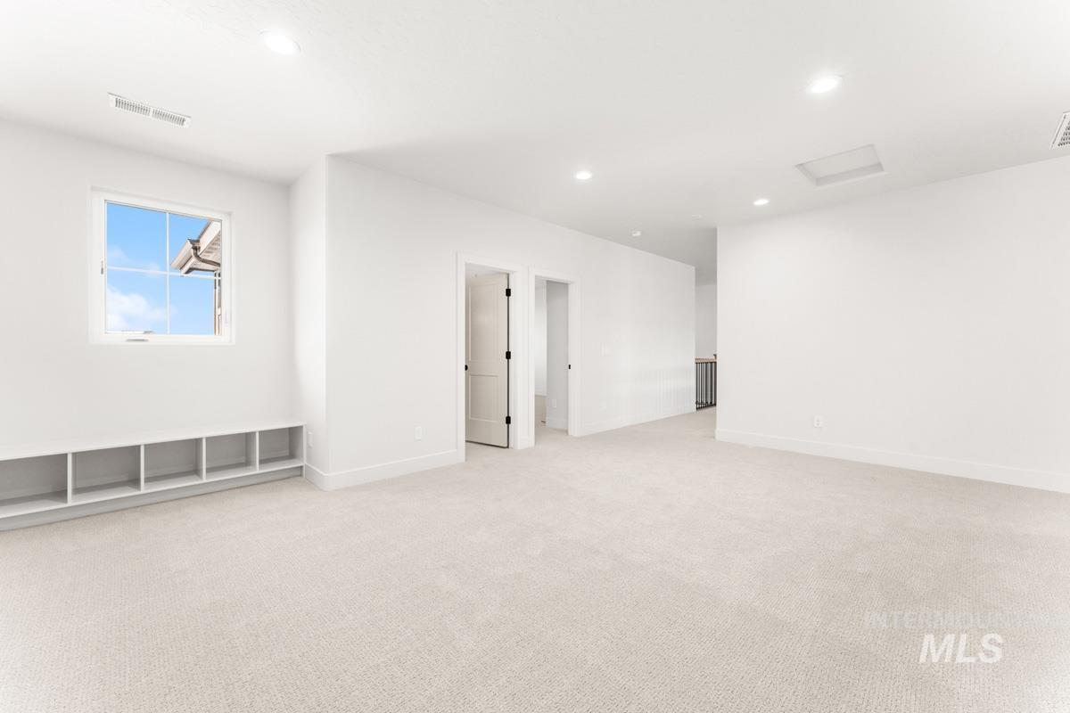 Empty room featuring light carpet and recessed lighting