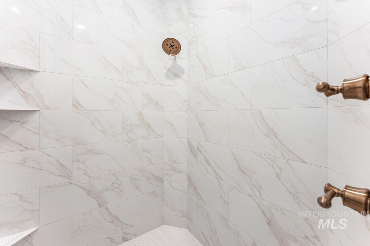 Full bath featuring tiled shower