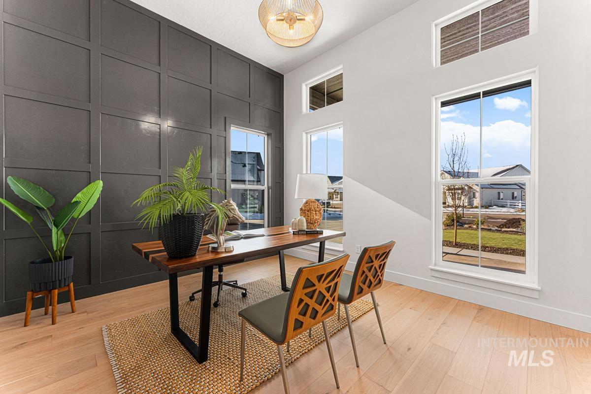 Office area featuring a decorative wall, light wood-style flooring, and an accent wall
