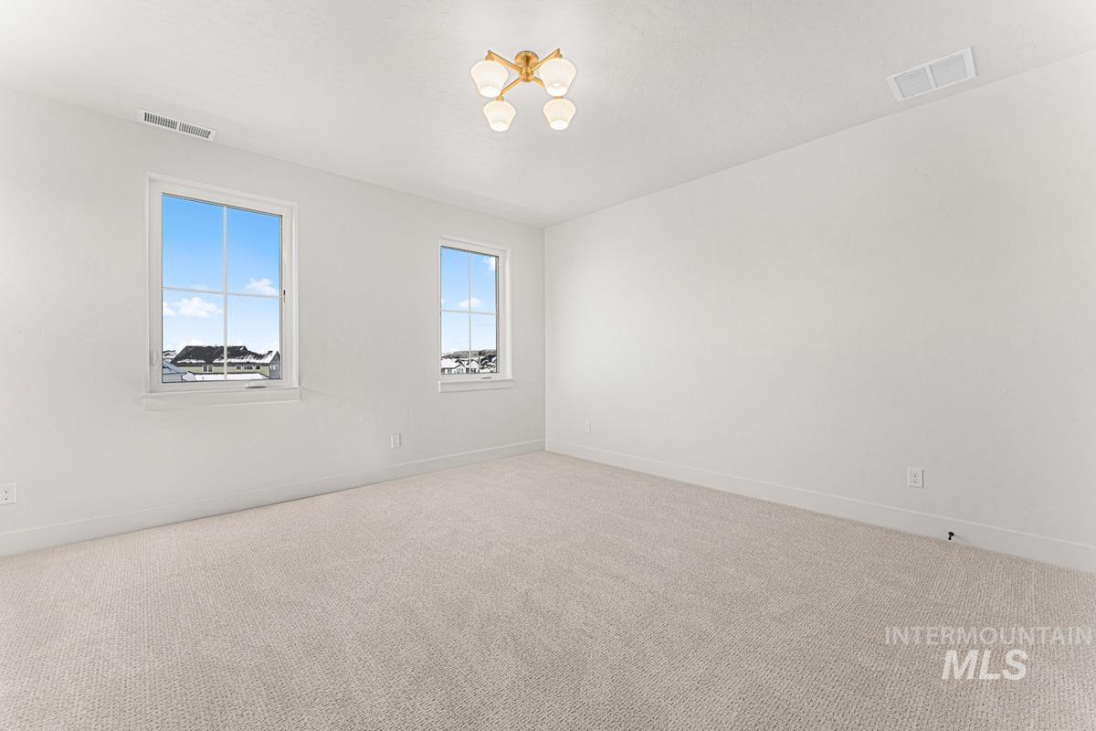 Unfurnished room with carpet and baseboards