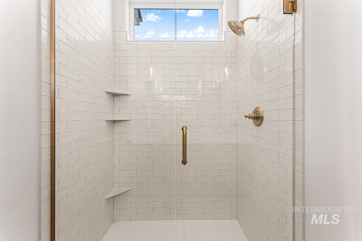 Full bathroom with a shower stall