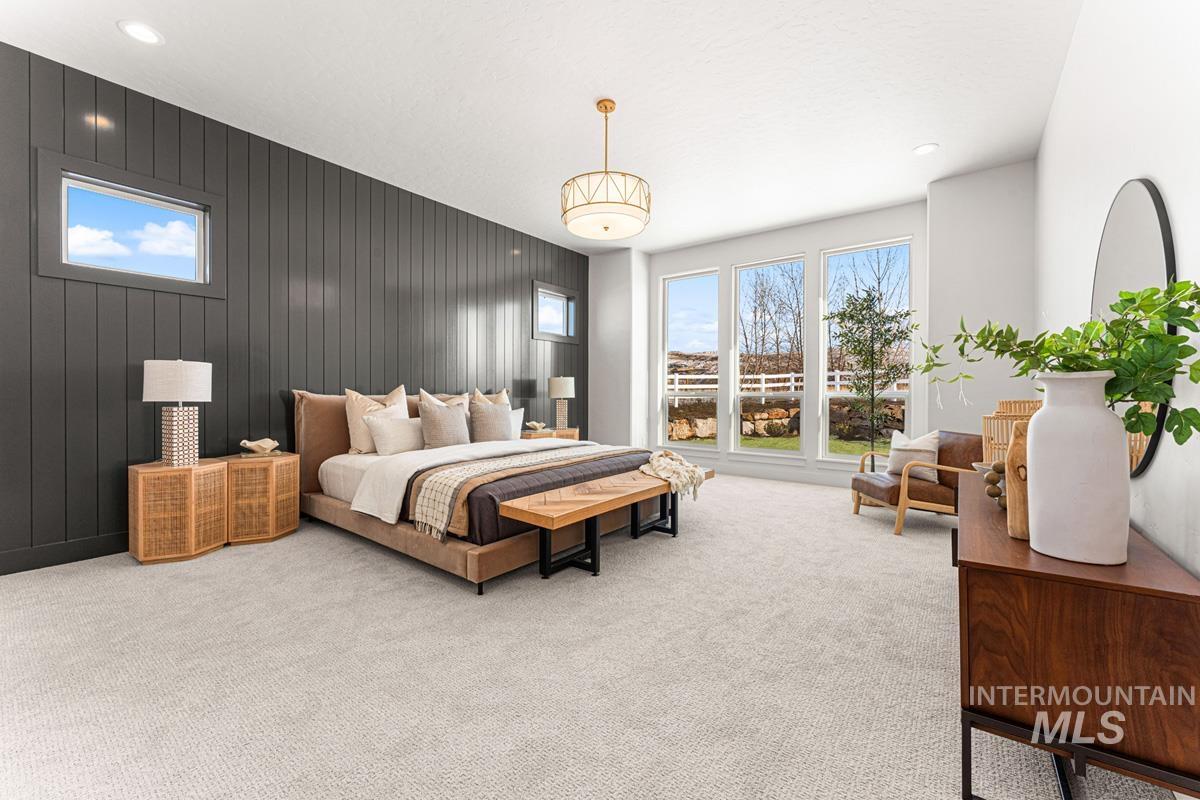 Bedroom with wooden walls, light carpet, recessed lighting, and an accent wall