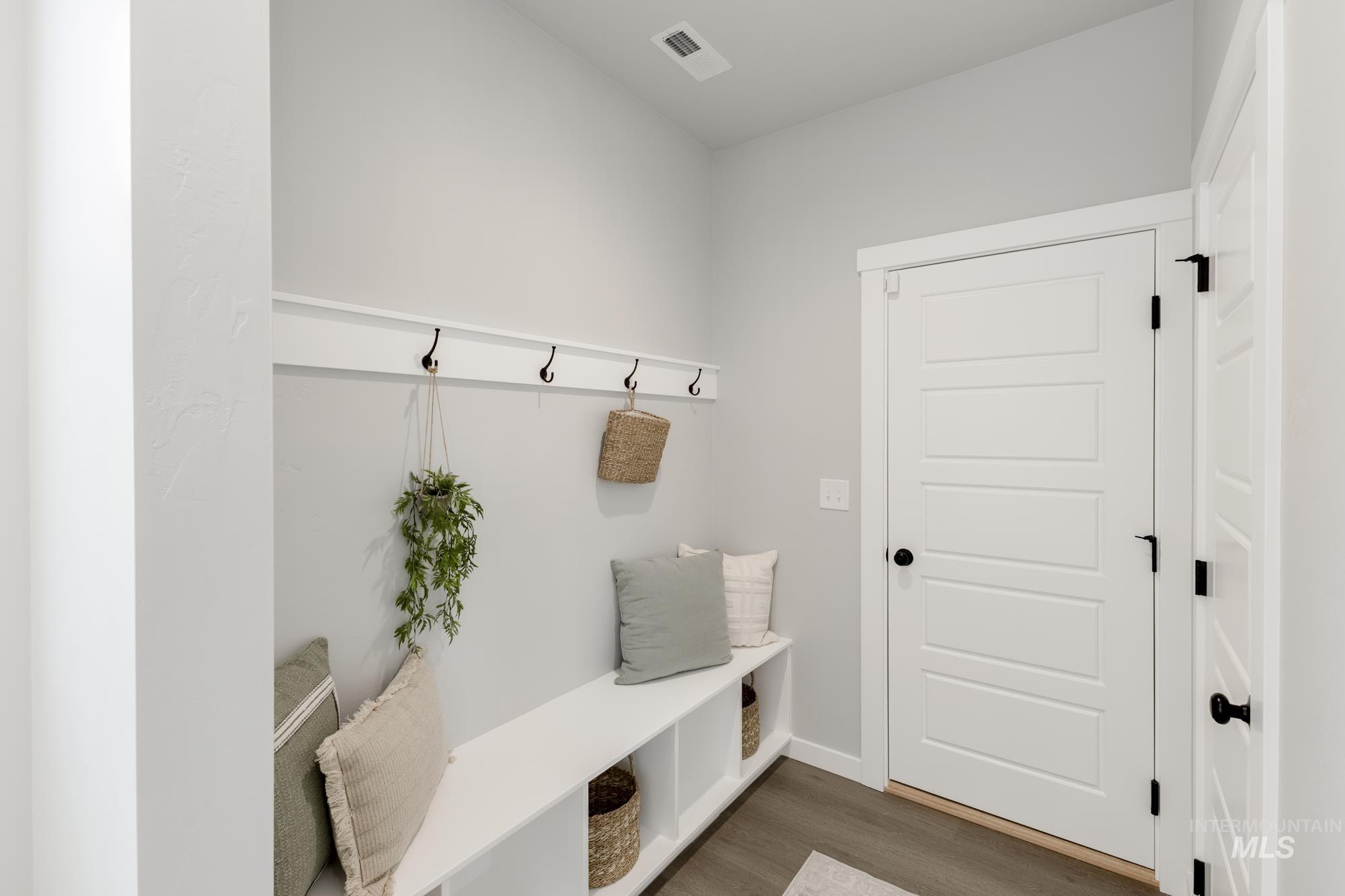 Mudroom featuring wood finished floors and baseboards