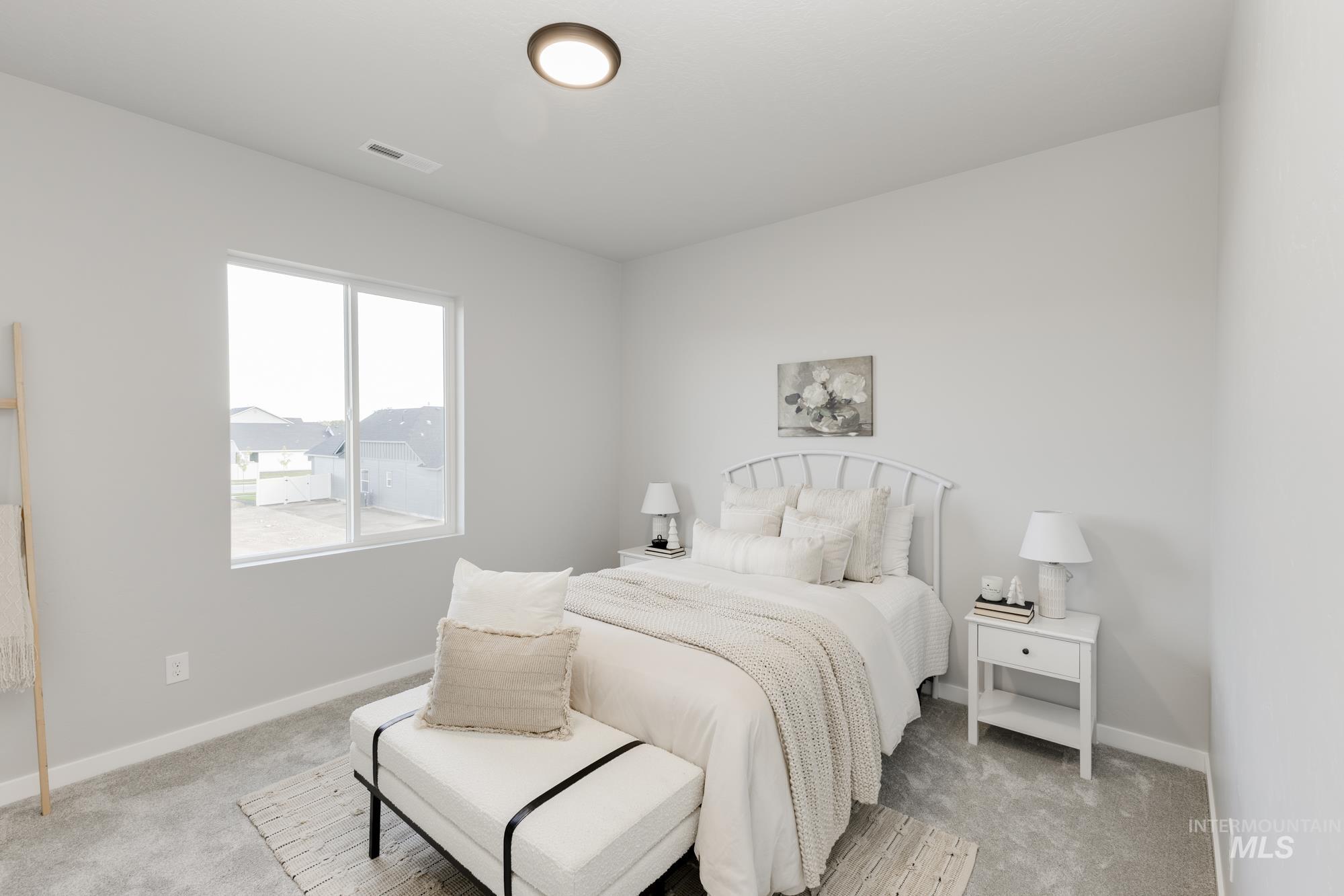 Bedroom featuring light colored carpet and baseboards