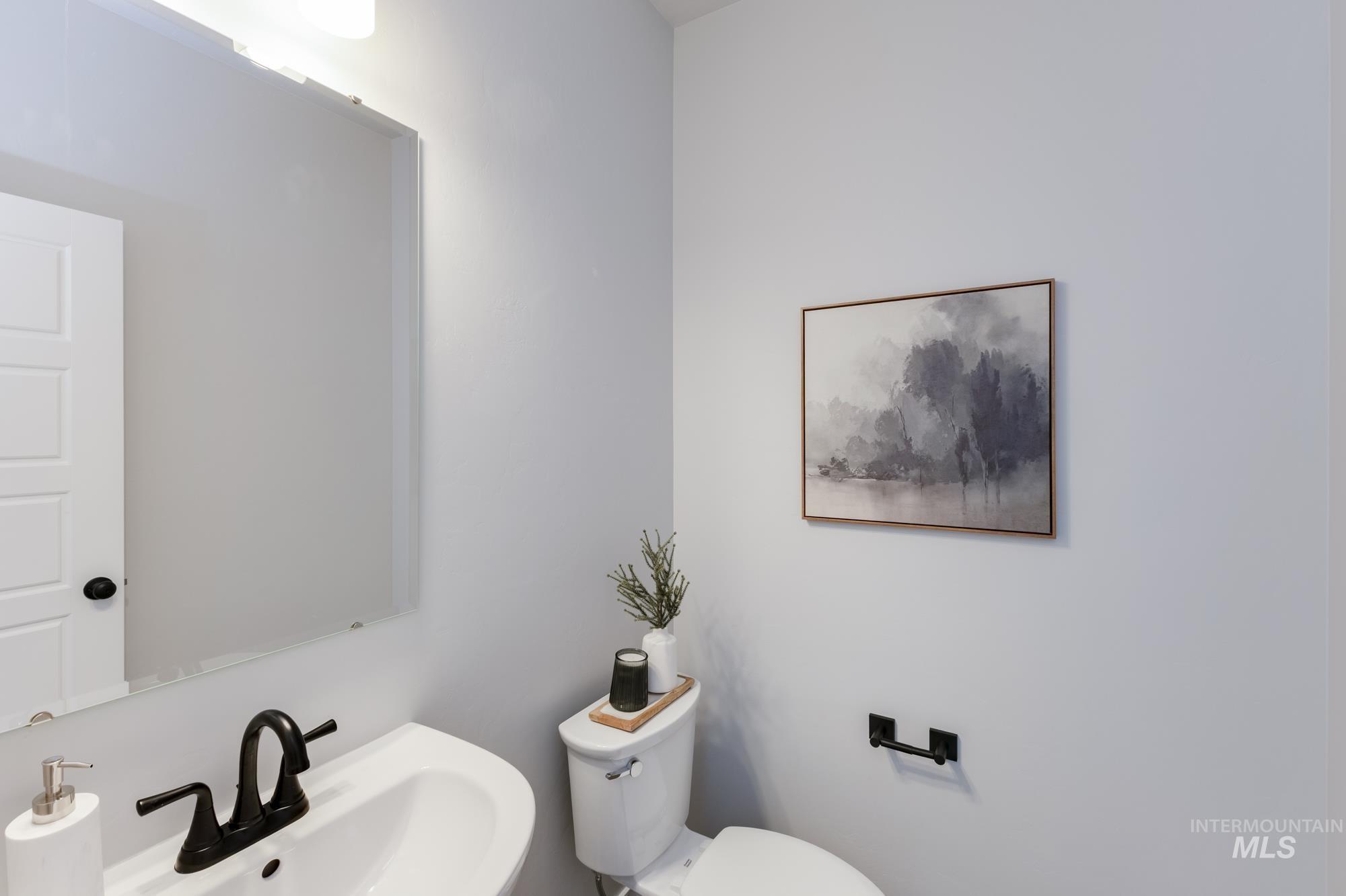 Half bathroom featuring a sink and toilet