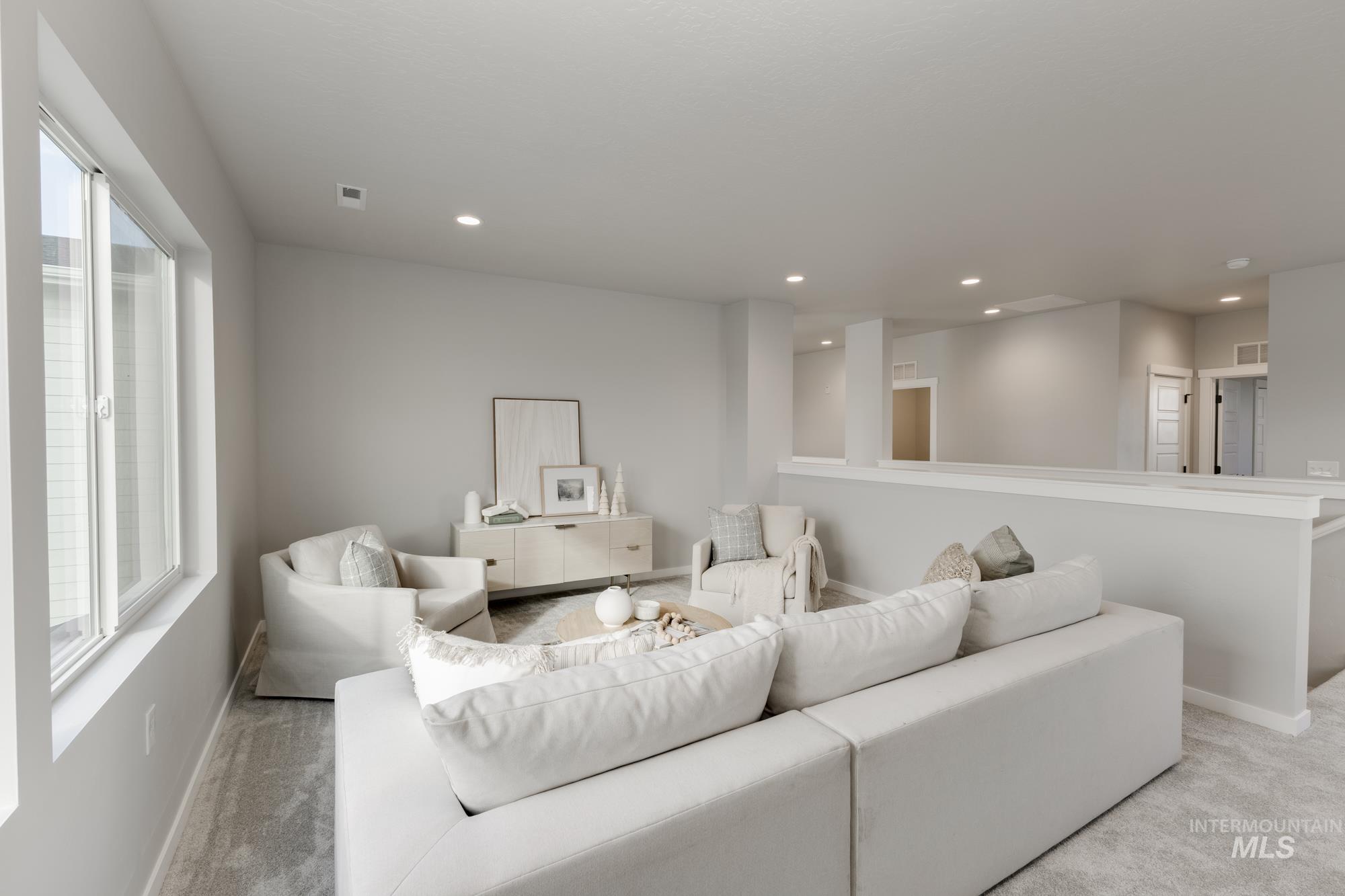 Living area with recessed lighting and carpet