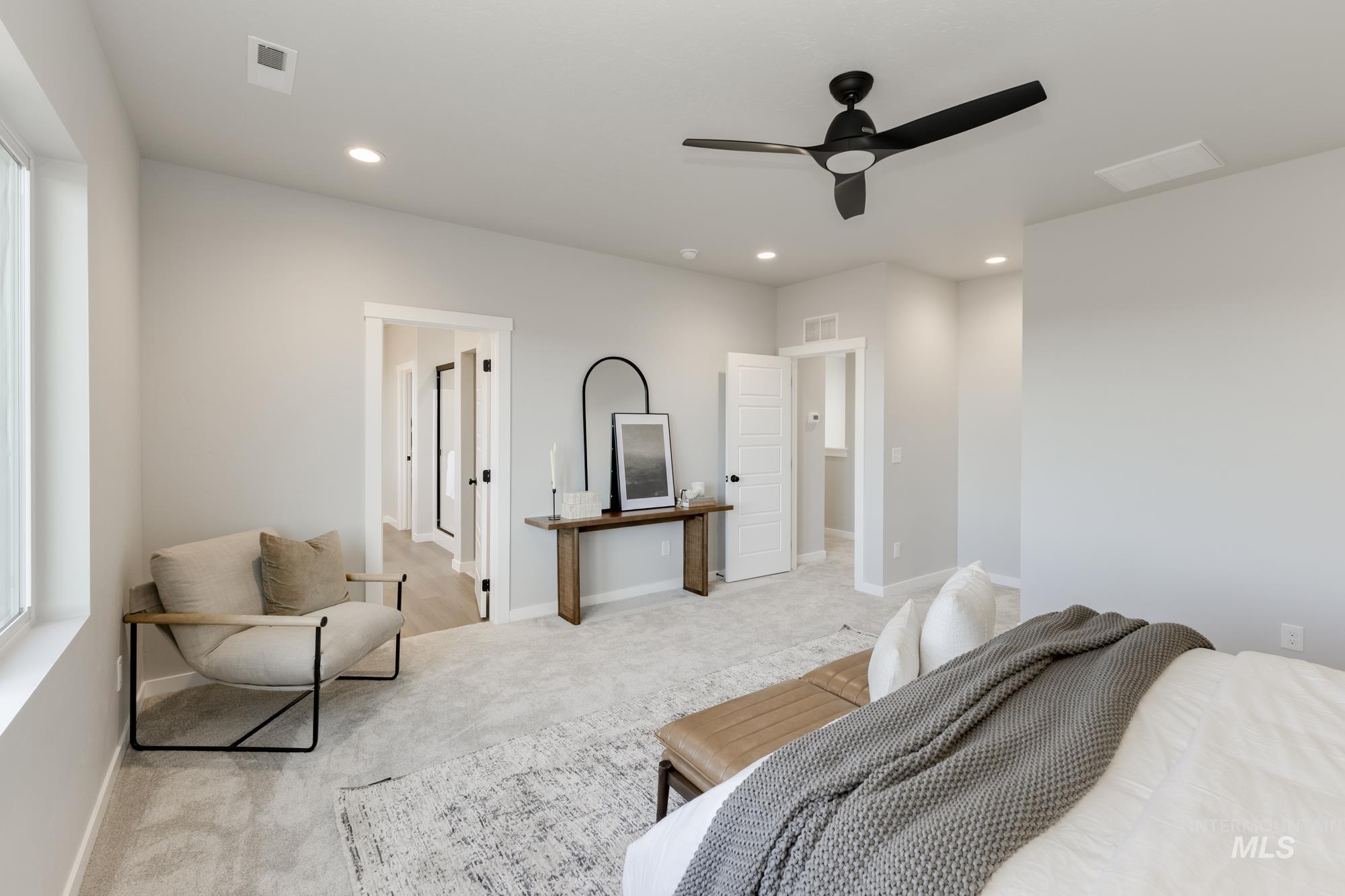 Carpeted bedroom featuring ceiling fan and recessed lighting
