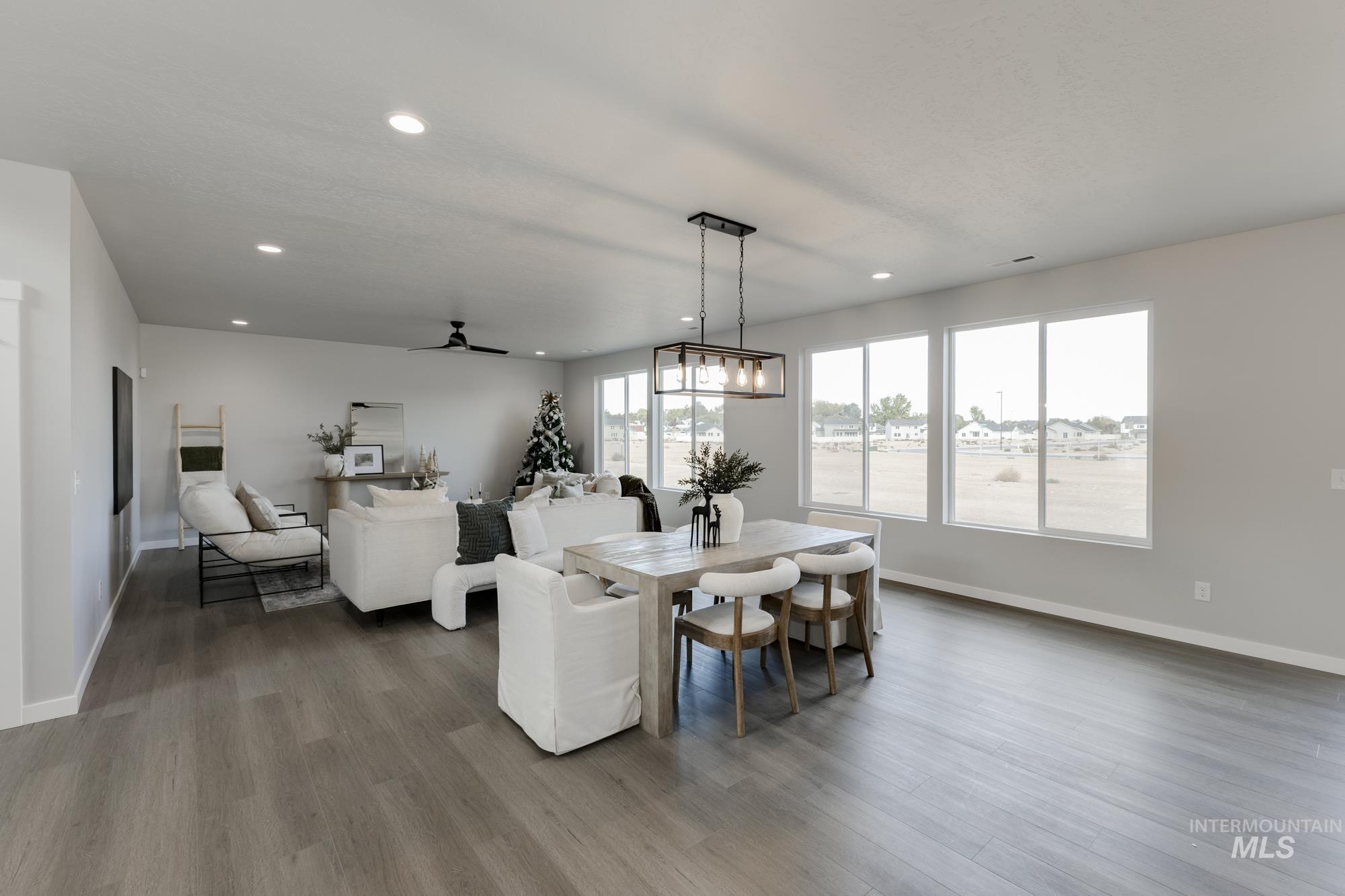 Dining space featuring ceiling fan, recessed lighting, wood finished floors, and a chandelier
