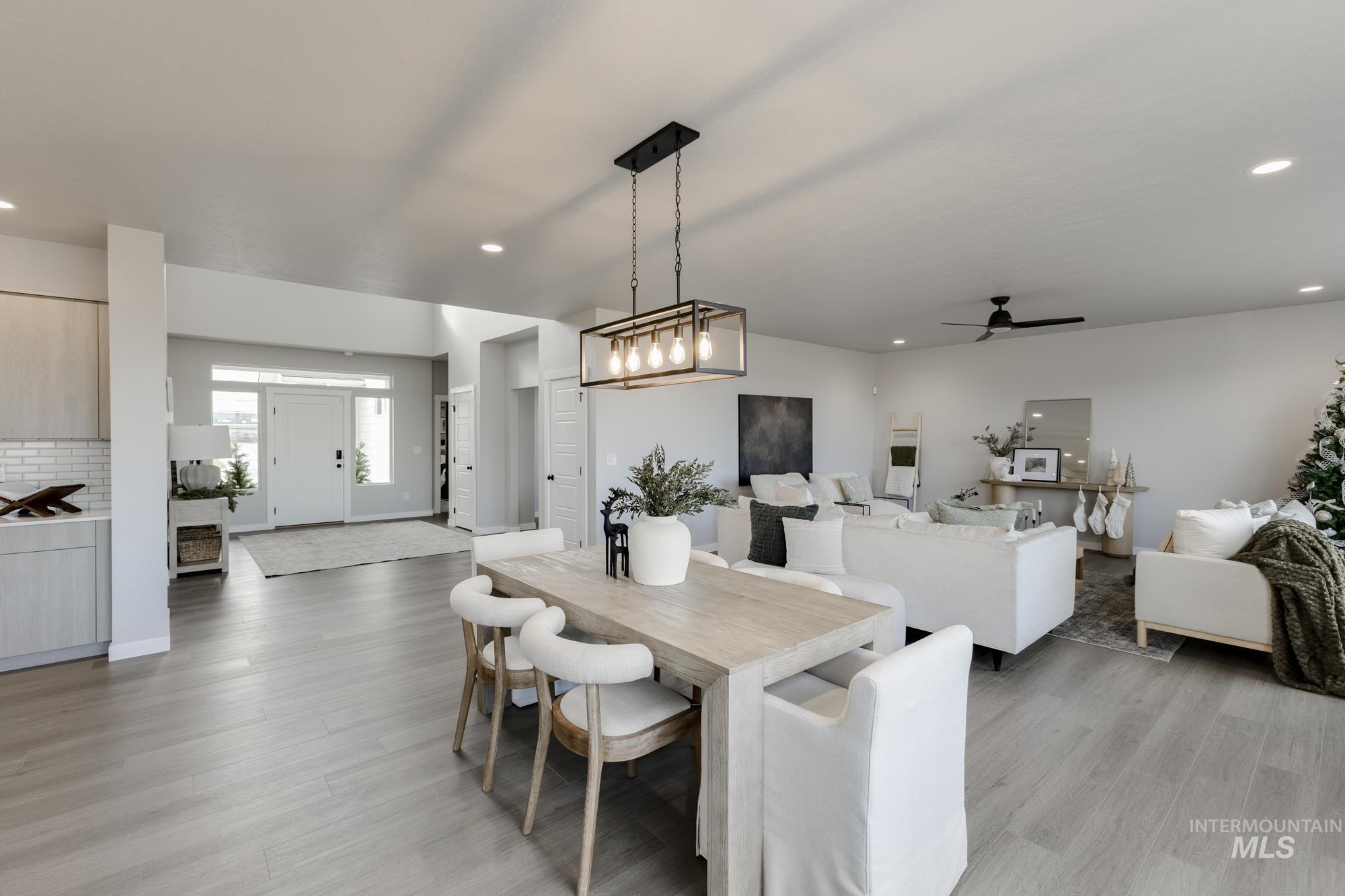 Dining area with light wood-style floors, recessed lighting, and a ceiling fan