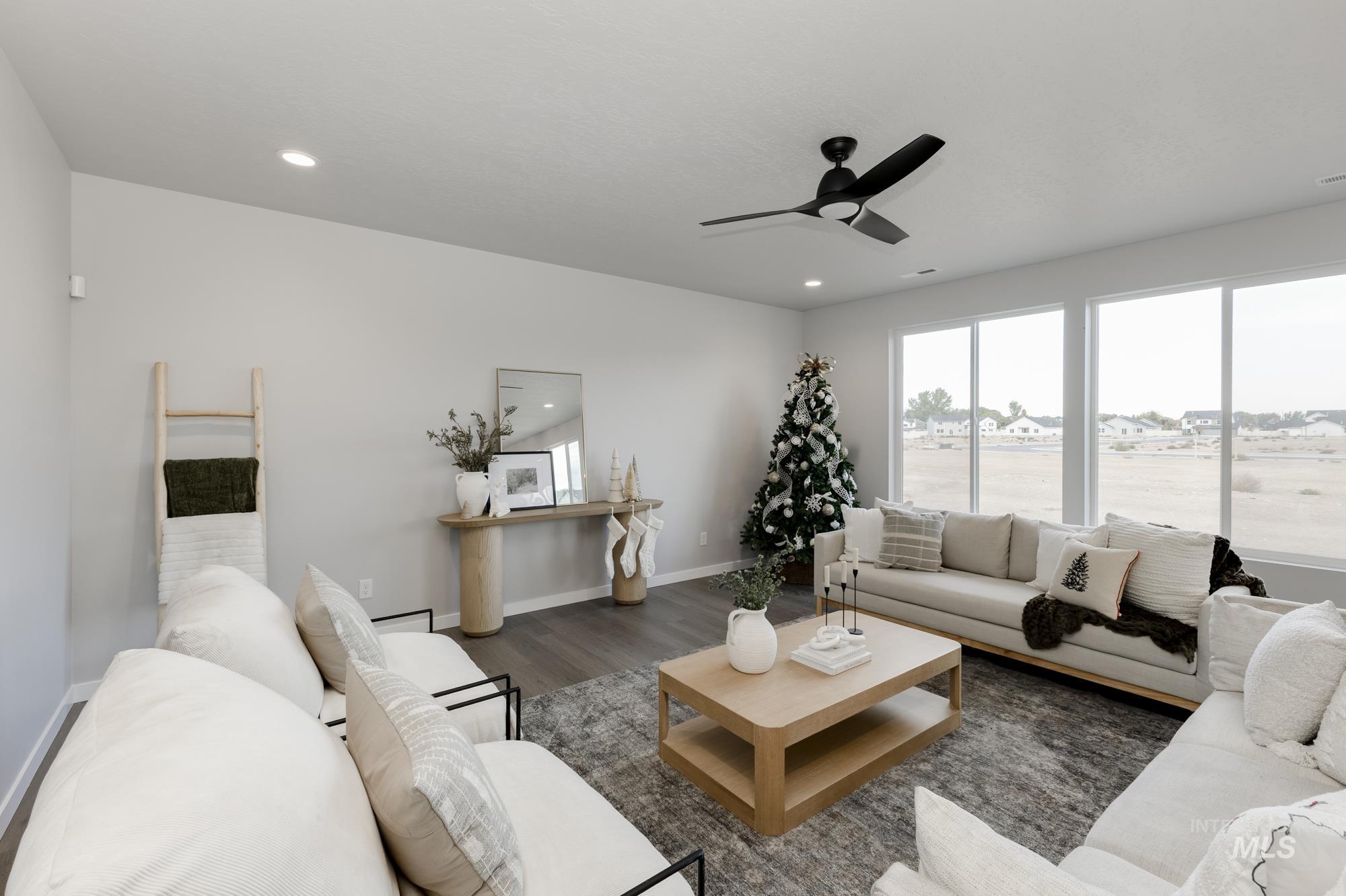 Living room featuring wood finished floors, ceiling fan, and recessed lighting