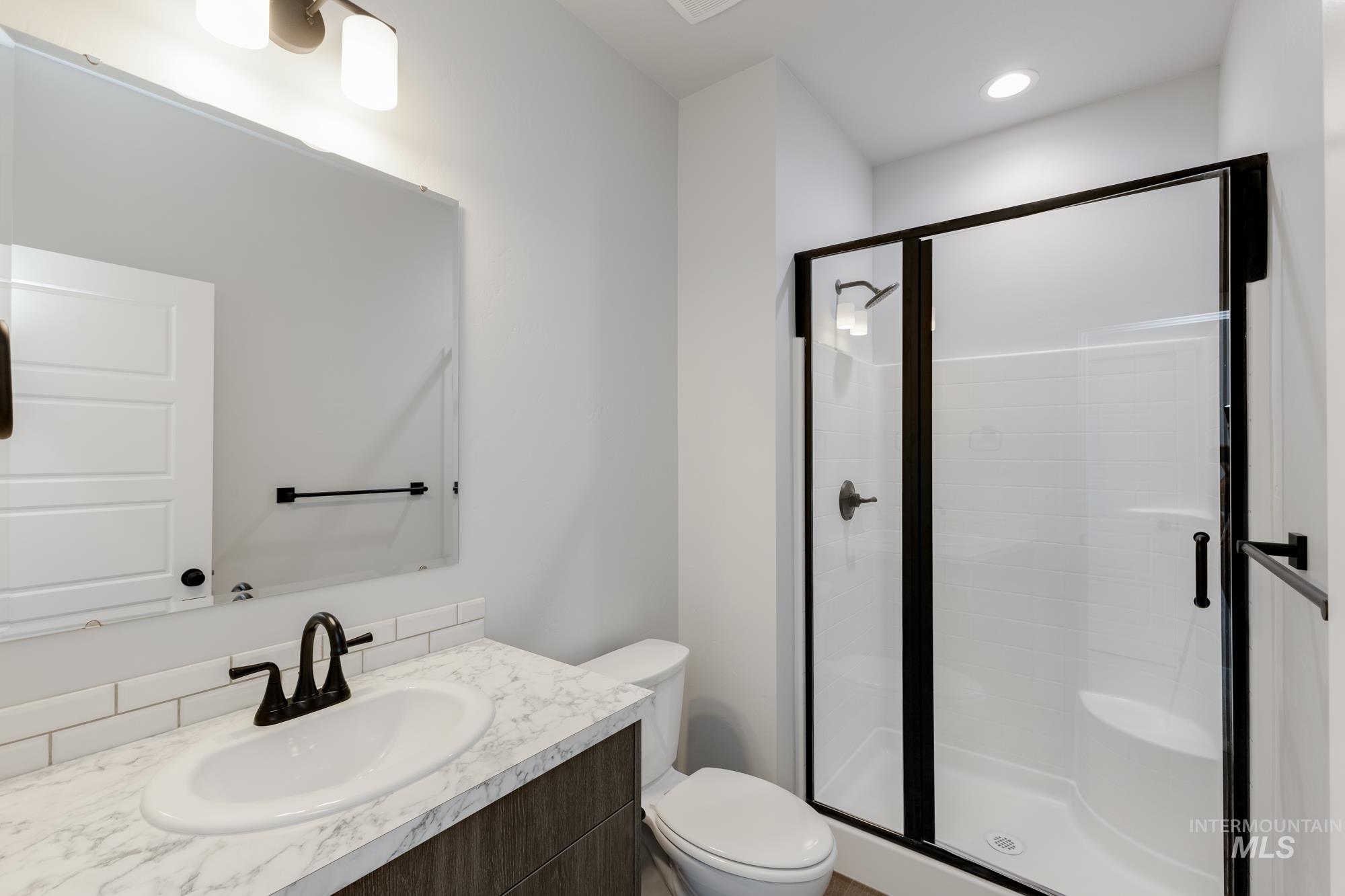 Bathroom with a shower stall and vanity