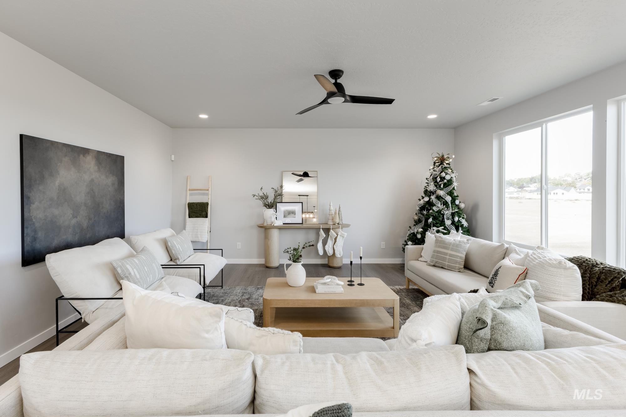 Living room featuring ceiling fan, wood finished floors, and recessed lighting