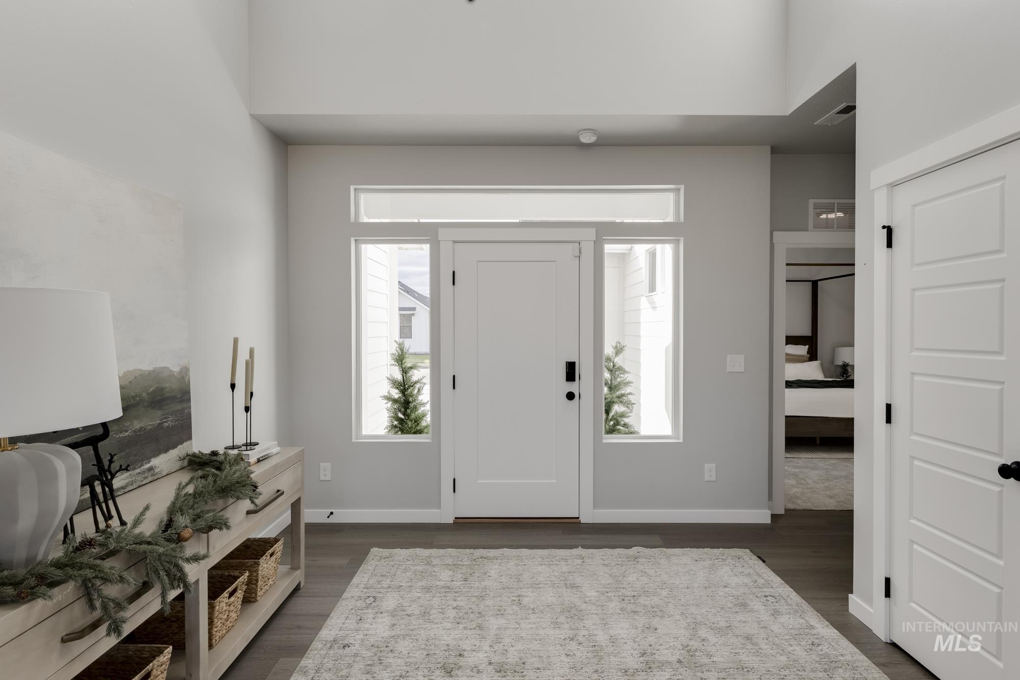 Foyer entrance featuring dark wood-style flooring