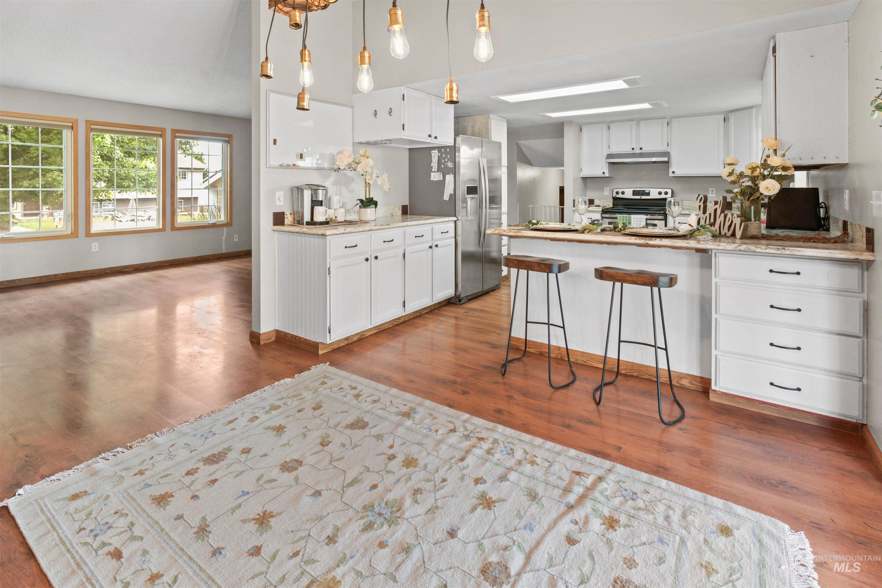 Open-concept layout featuring wood-finish flooring