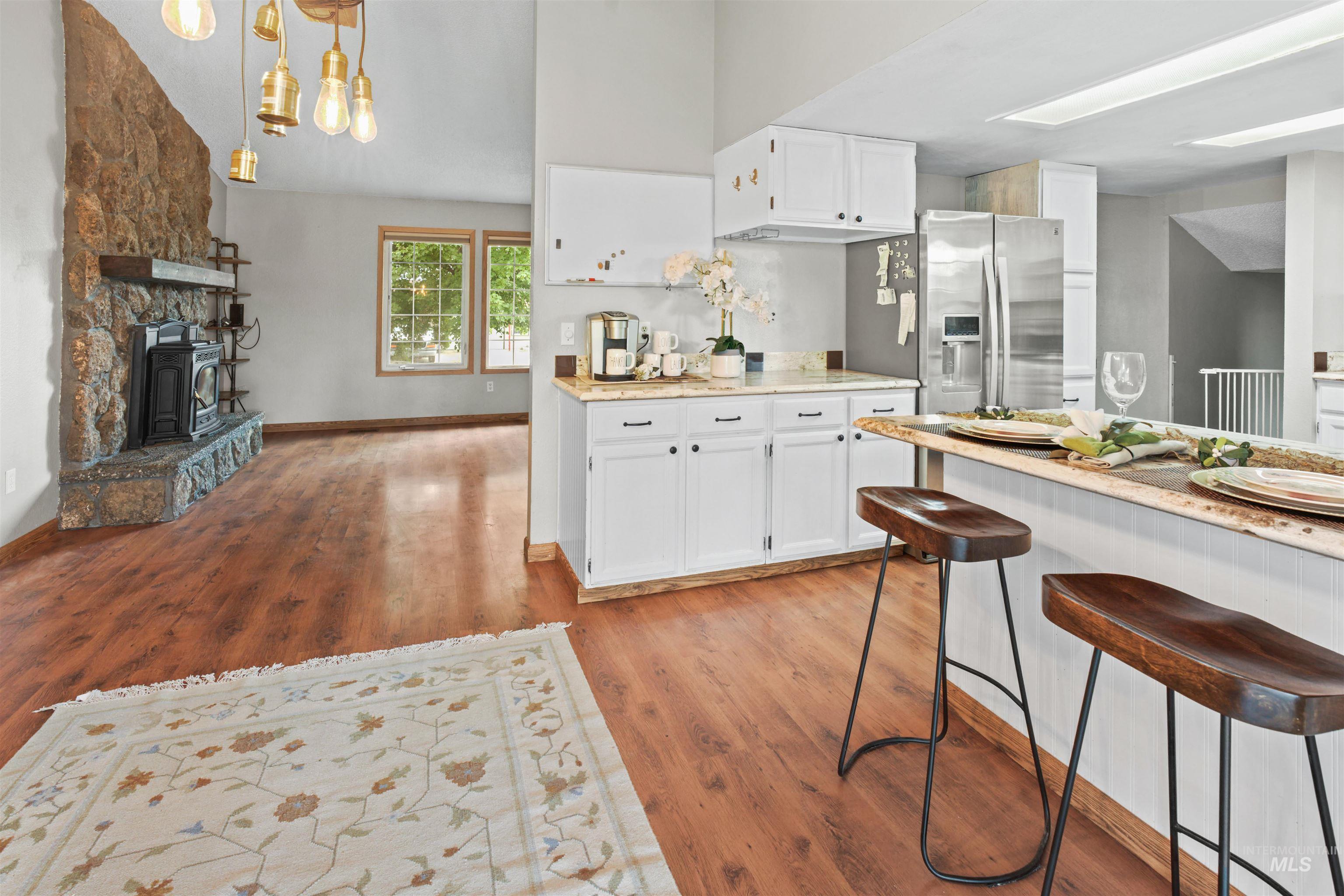Open-concept kitchen and living area featuring wood-finish flooring